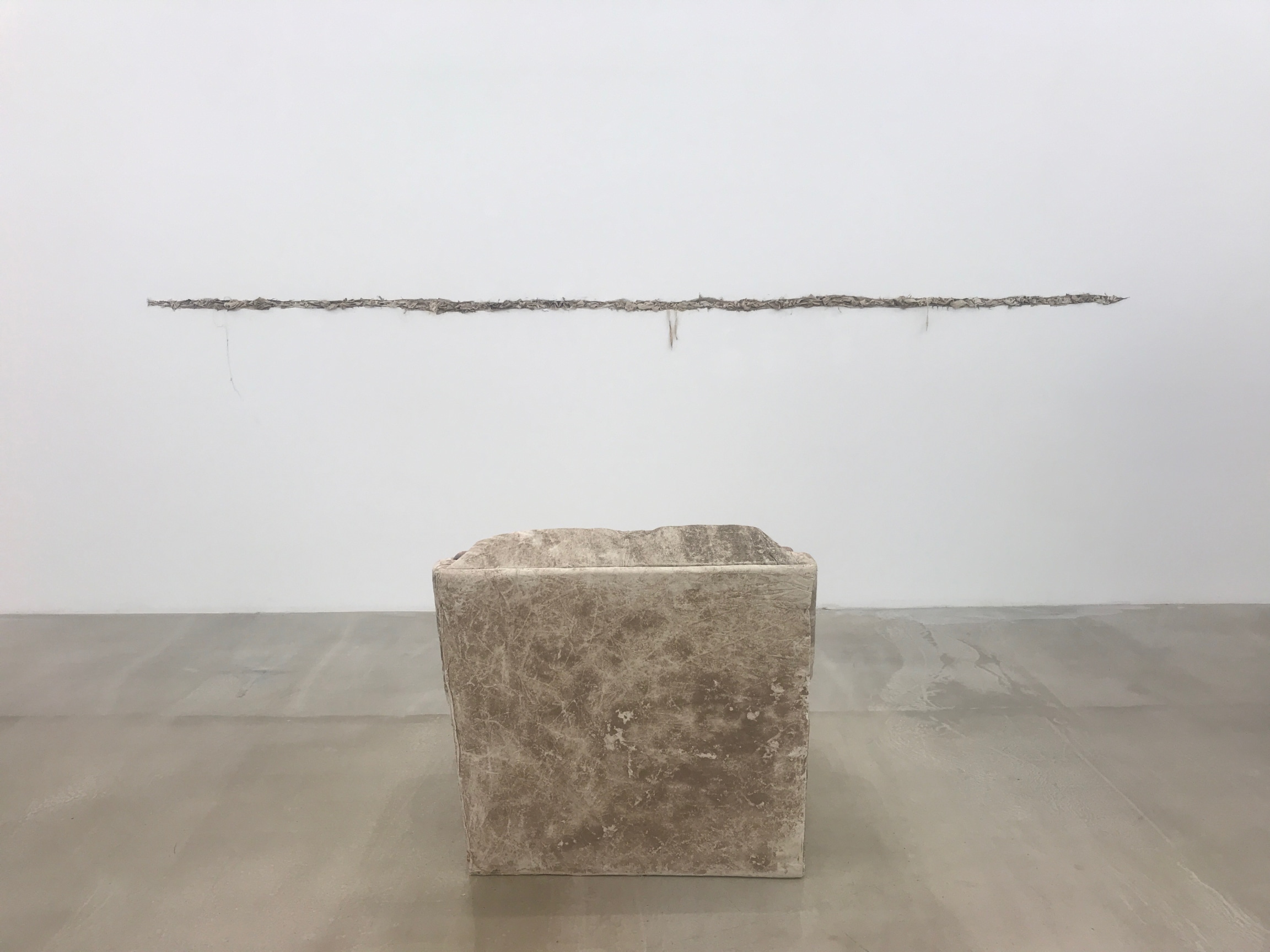 chair facing crack on the wall stuffed with cloth