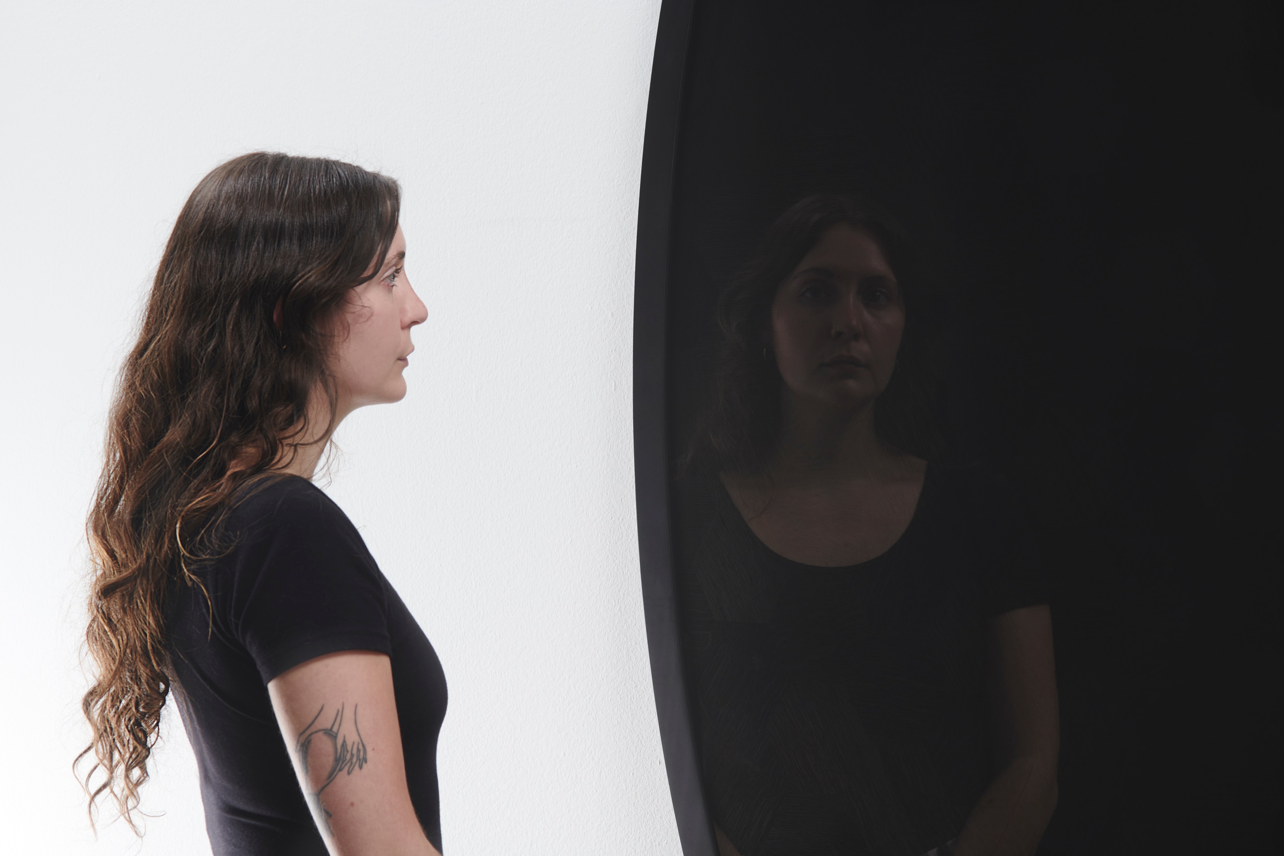 woman looking at a black oval