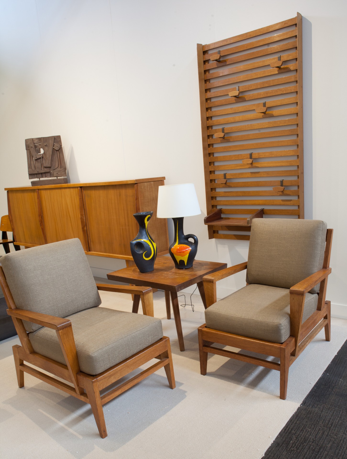 Magen H Gallery's booth at FOG Design + Art, pieces from left to right Ren&eacute; Gabriel's pair of armchairs, Marolles' side table, Gilbert Valentin/;es Archanges' ceramic vase and table lamp, and Attributed to Le Corbusier coatrack