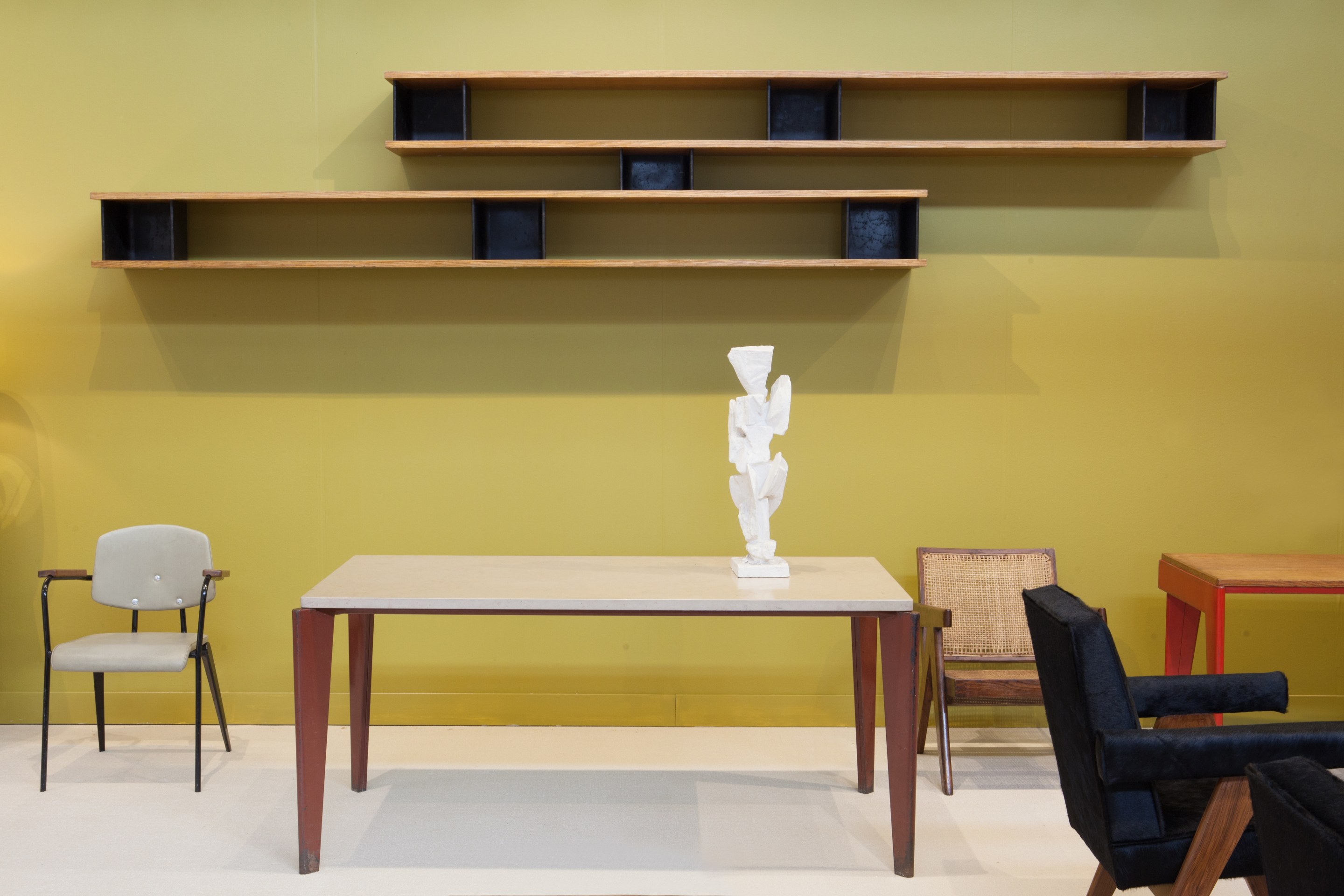 Magen H Gallery's booth at FOG Design + Art, pieces from left to right are Jean Prouv&eacute;'s Conference No 355 chair, Jean Prouv&eacute;'s Flavigny dining table, Charlotte Perriand's Nuage shelving, Alicia Penalba's &quot;Altar&quot; sculpture, Pierre Jeanneret's easy armchair and &quot;Committee&quot; armchair