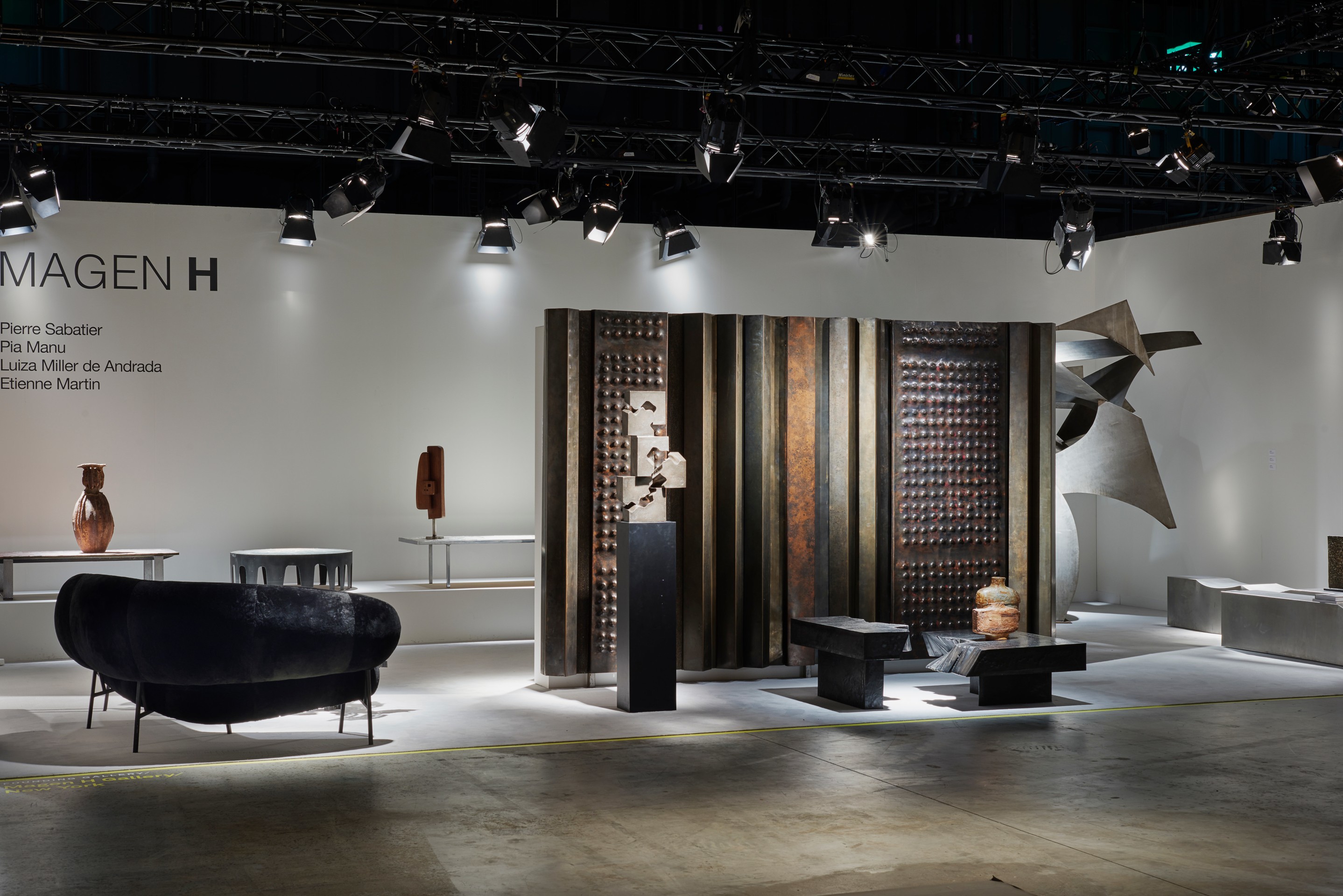 Magen H Gallery's booth at Design Miami/Basel, installation view of full booth showing Pierre Sz&eacute;kely's boomerang shaped sofa, Pierre Sabatier's &quot;Cascade&quot; sculpture, coffee table and &quot;Mur Vivant 70&quot; screen