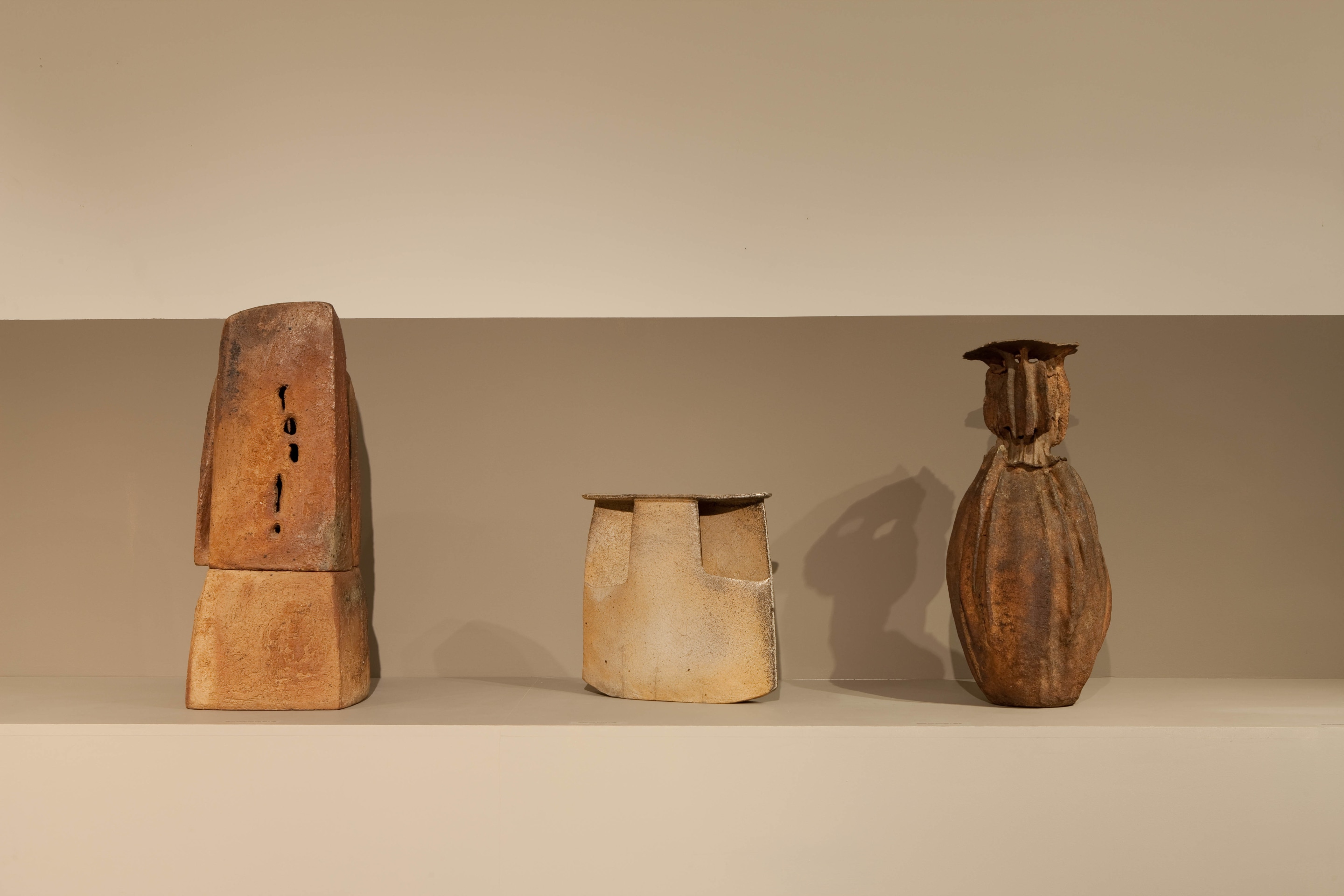 Lined up view of ceramic pieces from left to right: Hildegund Schlichenmaier and R&eacute;mi Bonhert's lamp (. 1966), Yves Mohy's large vase (c. 1977), and Hildegund / R&eacute;mi Schlichenmaier / Bonhert's vase (c. 1966)