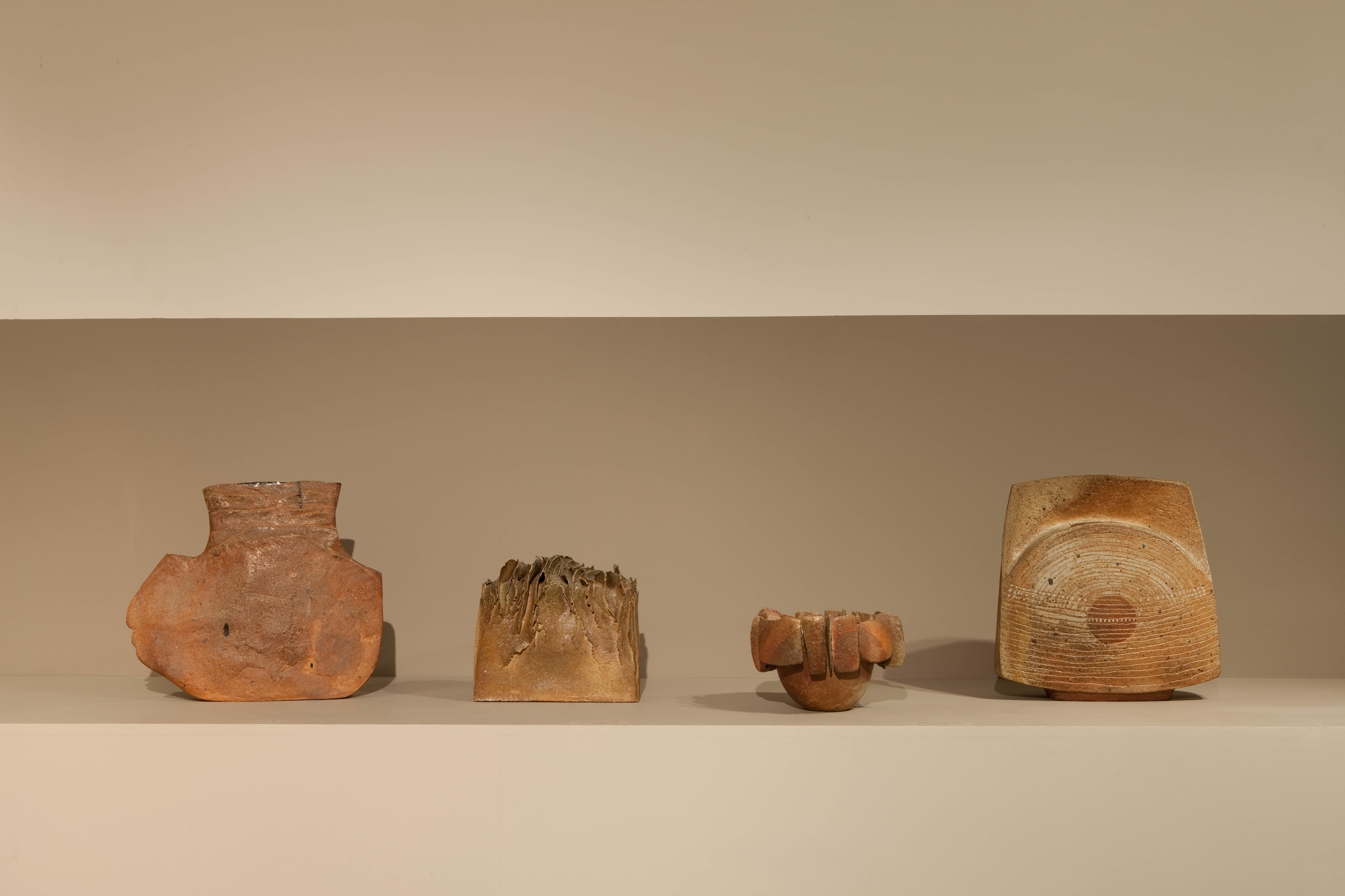 Lined up view of ceramic pieces from left to right: G&eacute;rard Brossards vase (c. 1968), Solange Garotte's sculpture (c. 1967), Monique Lacroix-Mohy's sculptural bowl (c. 1960), and Yves Mohy's large vase (c. 1963)
