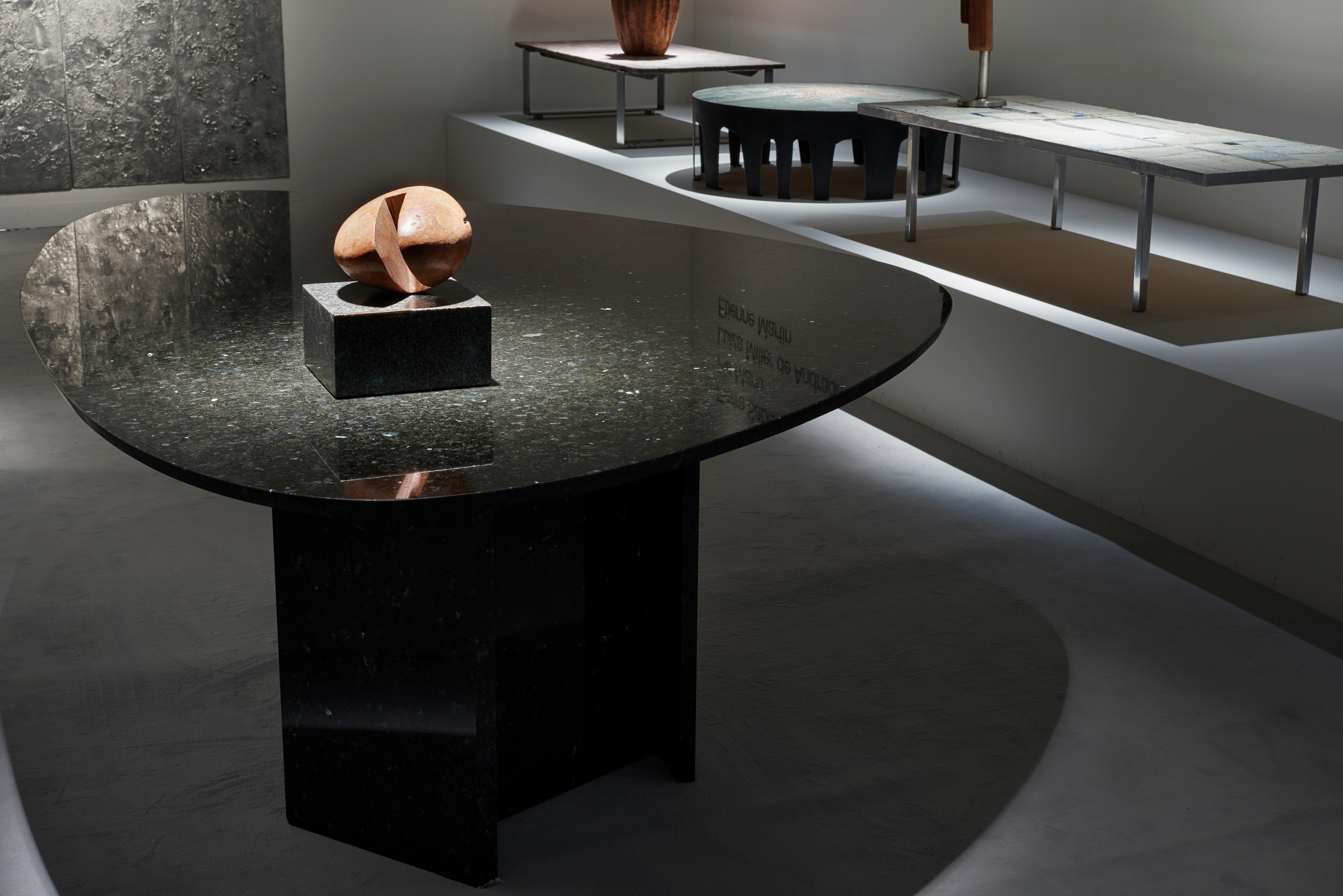 Magen H Gallery's booth at Design Miami/Basel, installation view showing Willy Ballez's dining table and Pierre Sz&eacute;kely's marble sculpture