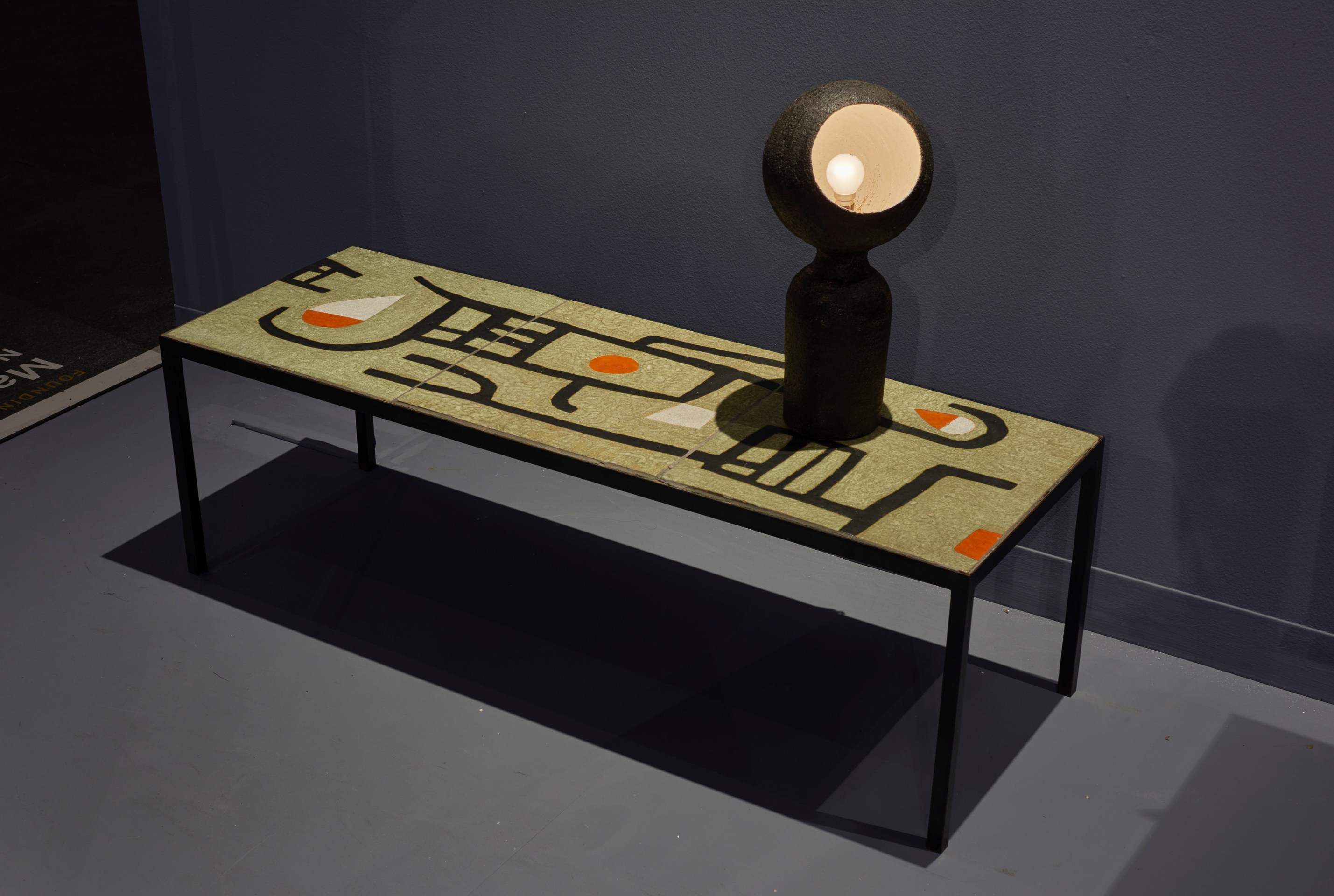 Magen H Gallery's booth at Design Miami, install image of Andre Borderie's ceramic coffee table with Borderie's Tete a Lumiere