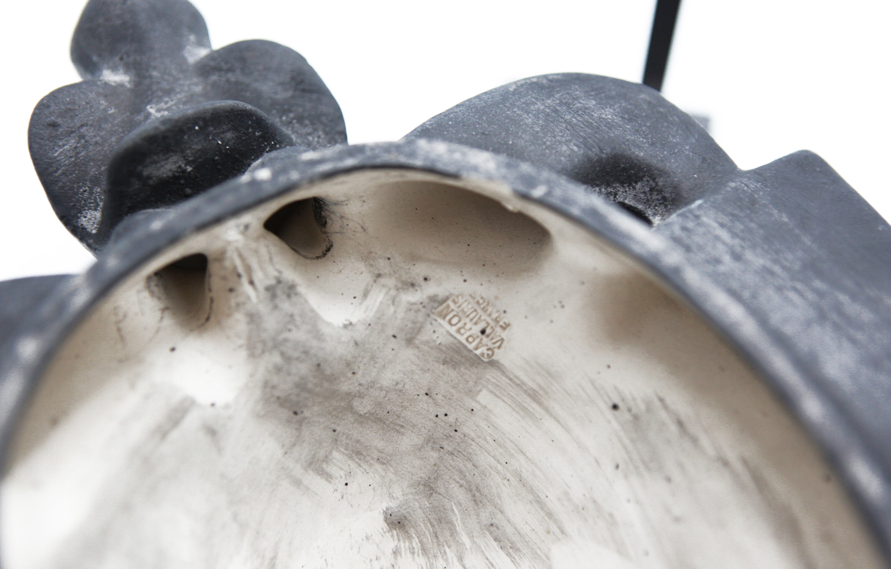 Roger Capron's ceramic mask detail view of signature inside the mask