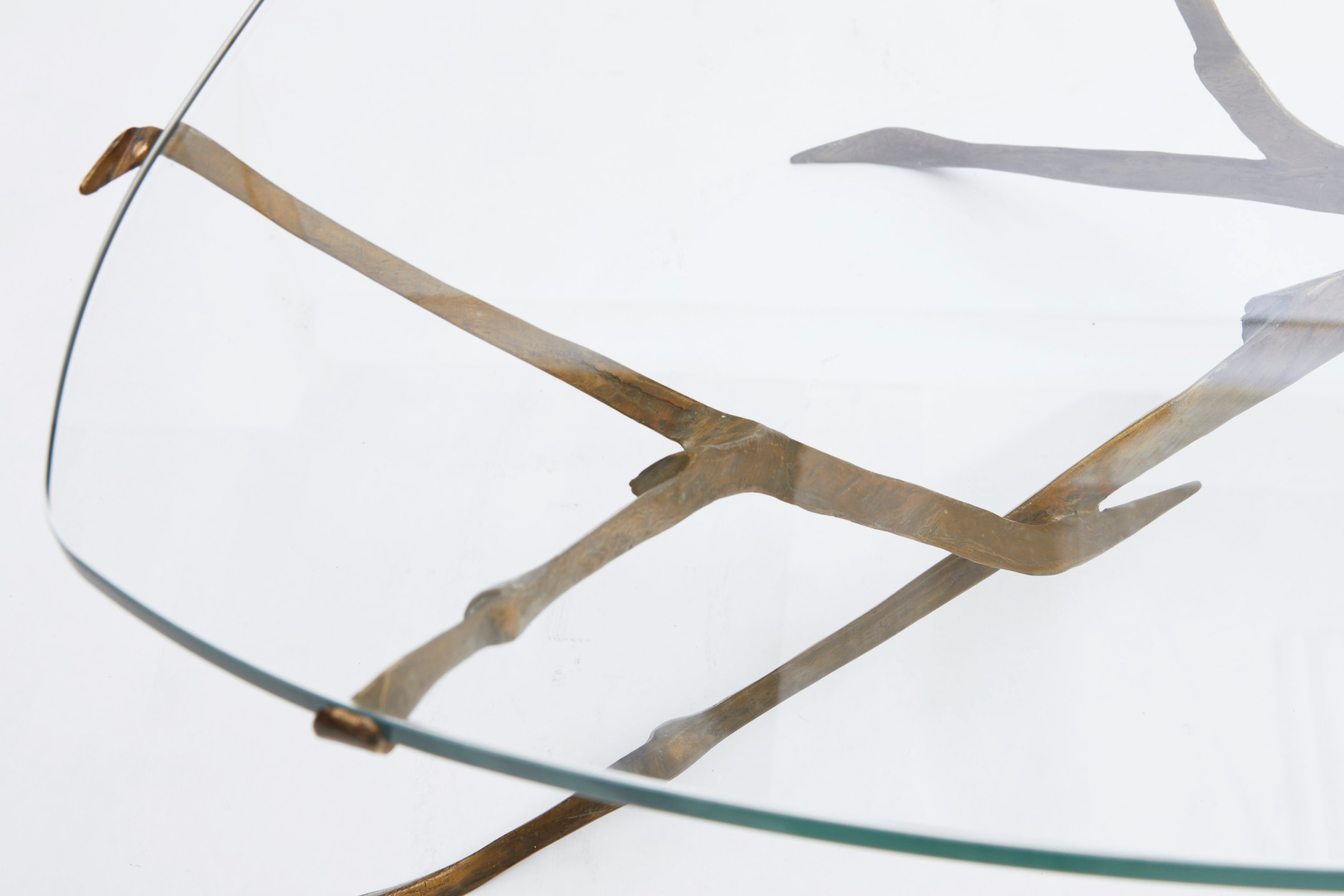 Felix Agostini's coffee table view of glass top with bronze base