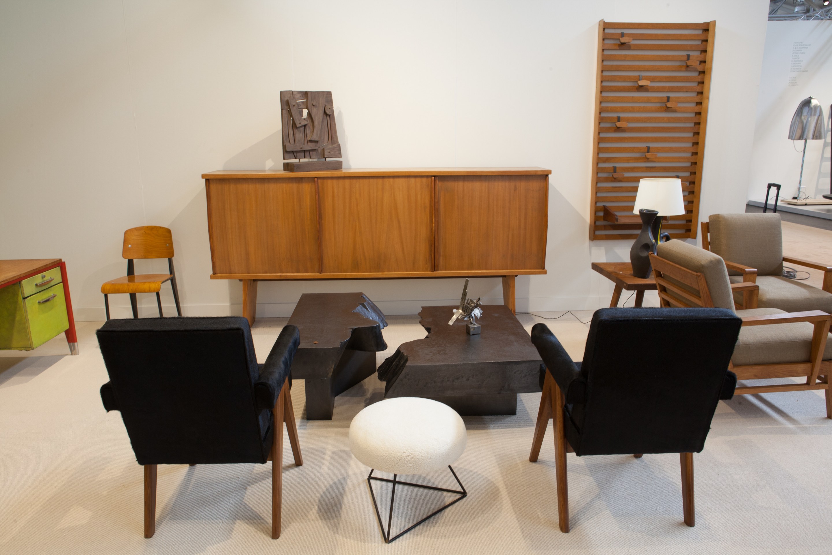 Magen H Gallery's booth at FOG Design + Art, pieces from left to right Pierre Jeanneret's pair of &quot;Committee&quot; armchairs, Charlotte Perriands &amp; Pierre Jeanneret's sideboard, Ricardo Santamaria's sculpture, Pierre Sabatier's San Andrea's coffee table, In the style of Pierre Guariche's stool, and Albert Feruad's sculpture