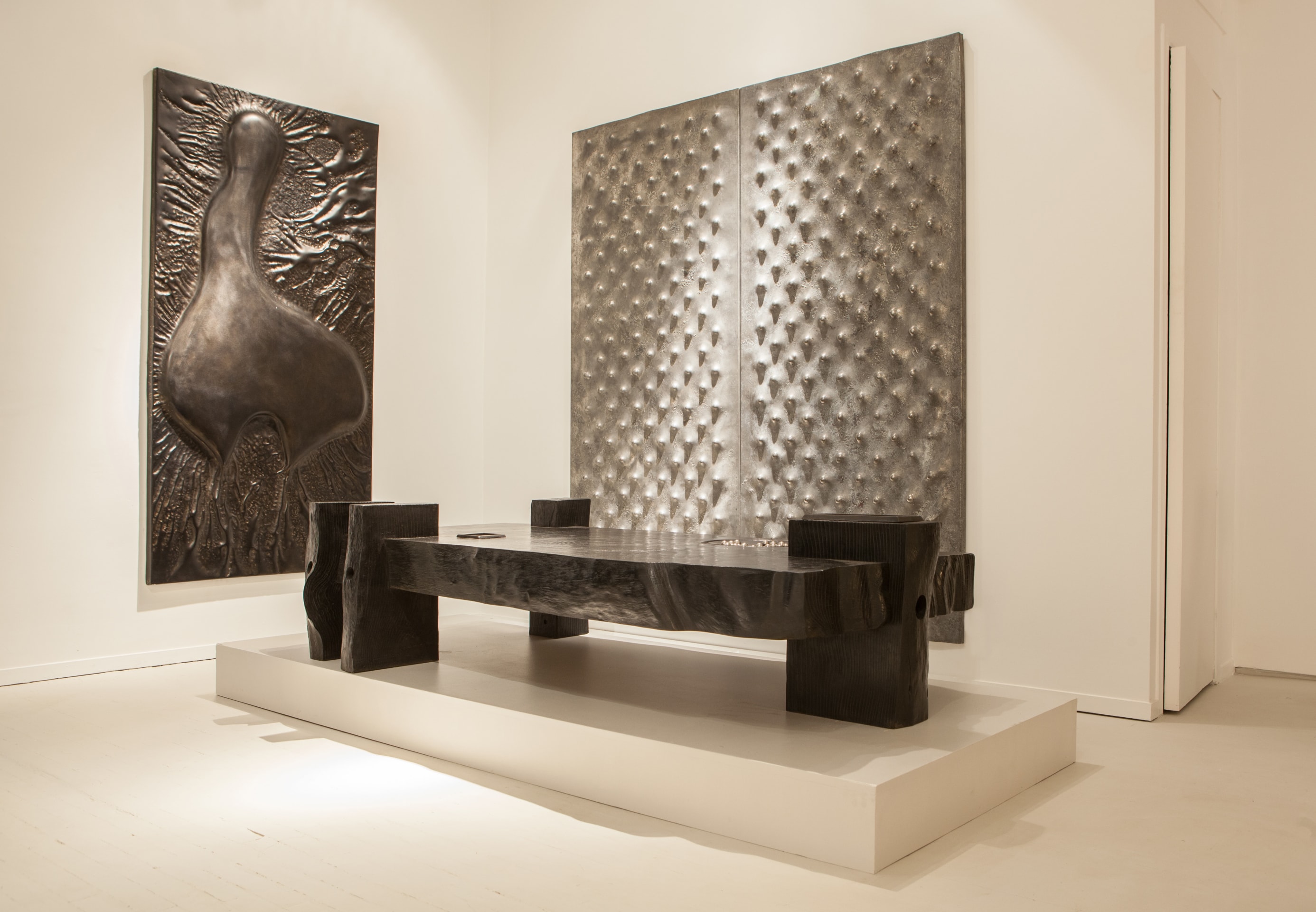 Pierre Sabatier exhibition installation view: displaying &quot;Genese&quot; wall sculpture, &quot;Dots III and Dots IV&quot; set of two wall sculpture with the &quot;Solitaire&quot; coffee table in front