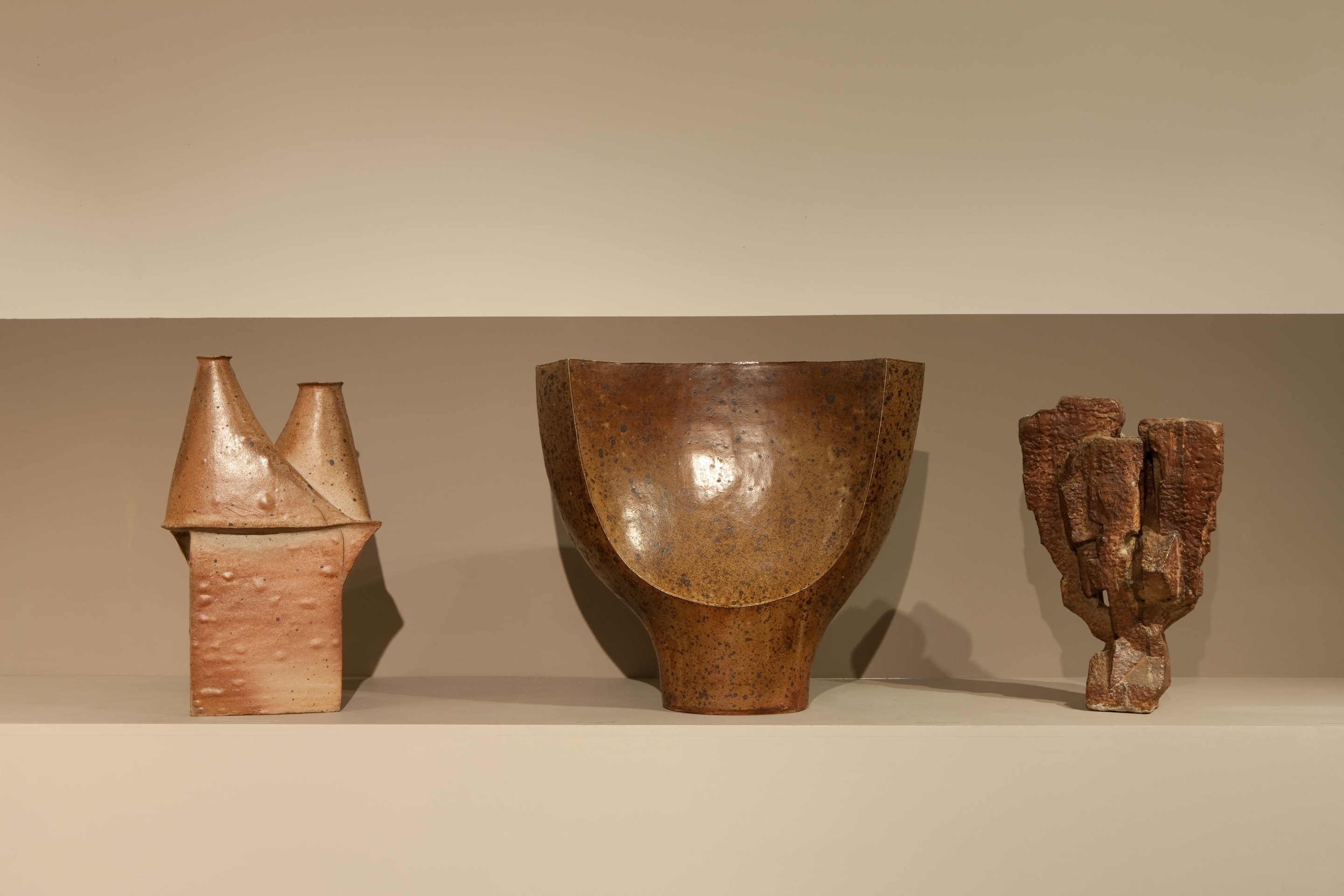 Lined up view of ceramic pieces from left to right: Yves Mohy's vase (c. 1965), Gustave Tiffoche's vase (c. 1968), and Jo&euml;lle Deroubaix's large sculpture (c. 1972)
