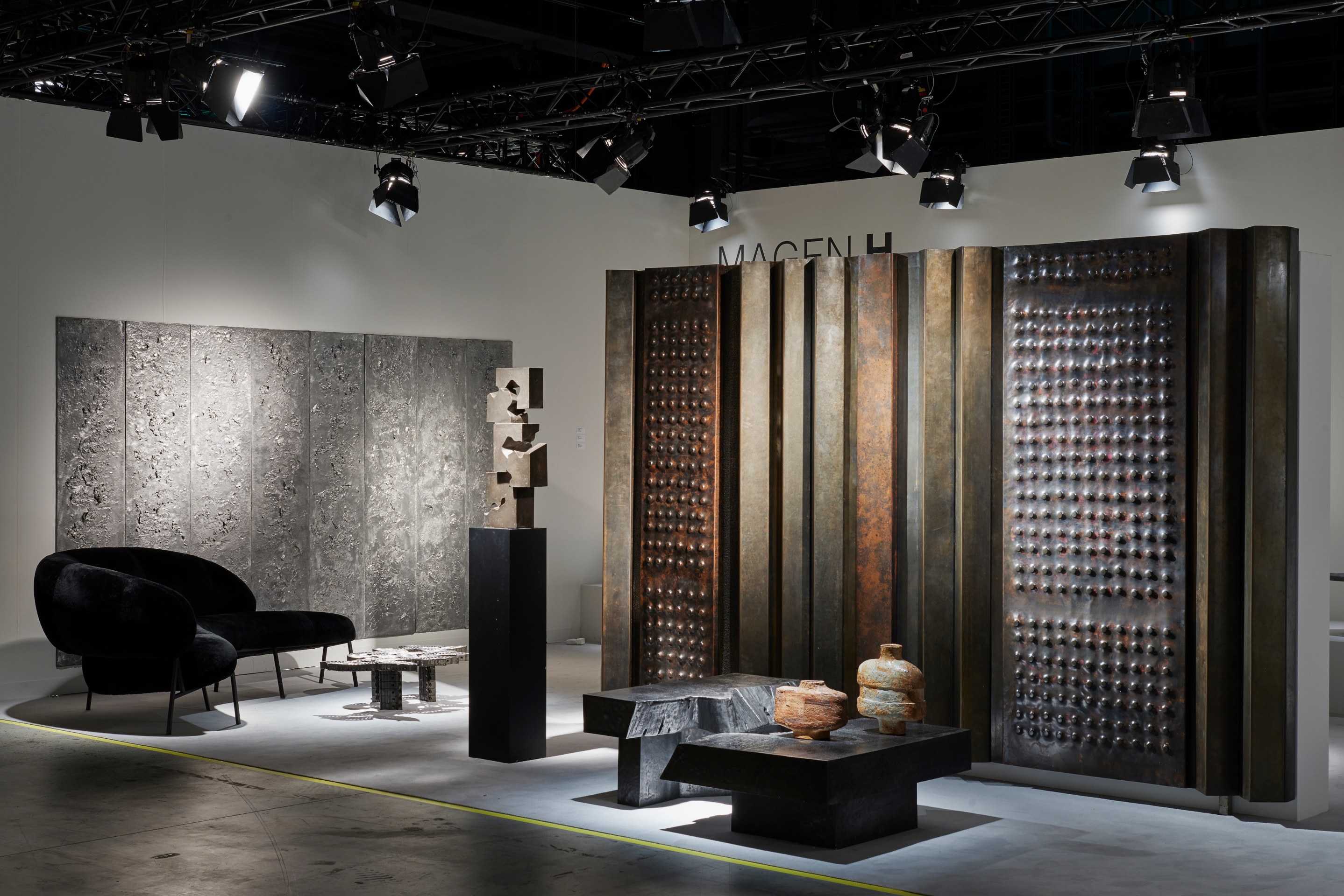 Magen H Gallery's booth at Design Miami/Basel, installation view of full booth showing Luiza Miller's set of eight panels, Pierre Sz&eacute;kely's boomerang shaped sofa, Luiza Millers' coffee table, Pierre Sabatier's &quot;Cascade&quot; sculpture, coffee table and &quot;Mur Vivant 70&quot; screen, Jean and Jacqueline Lerat's ceramic vase and Jean Lerat's ceramic vase