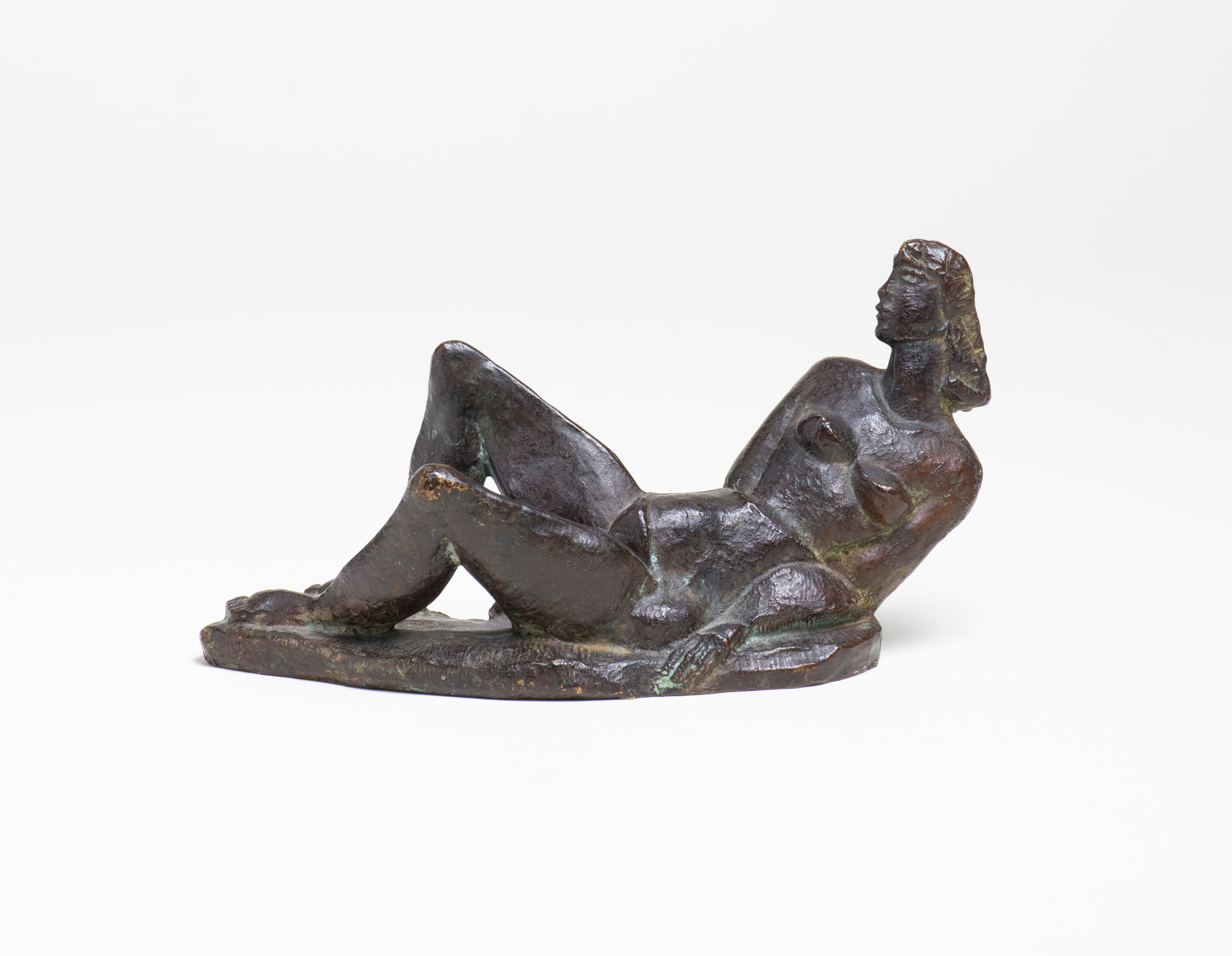 an angular sculpture by robert laurent of a reclining nude figure, rough textured bronze, the pose angular and the figure stylized and angular