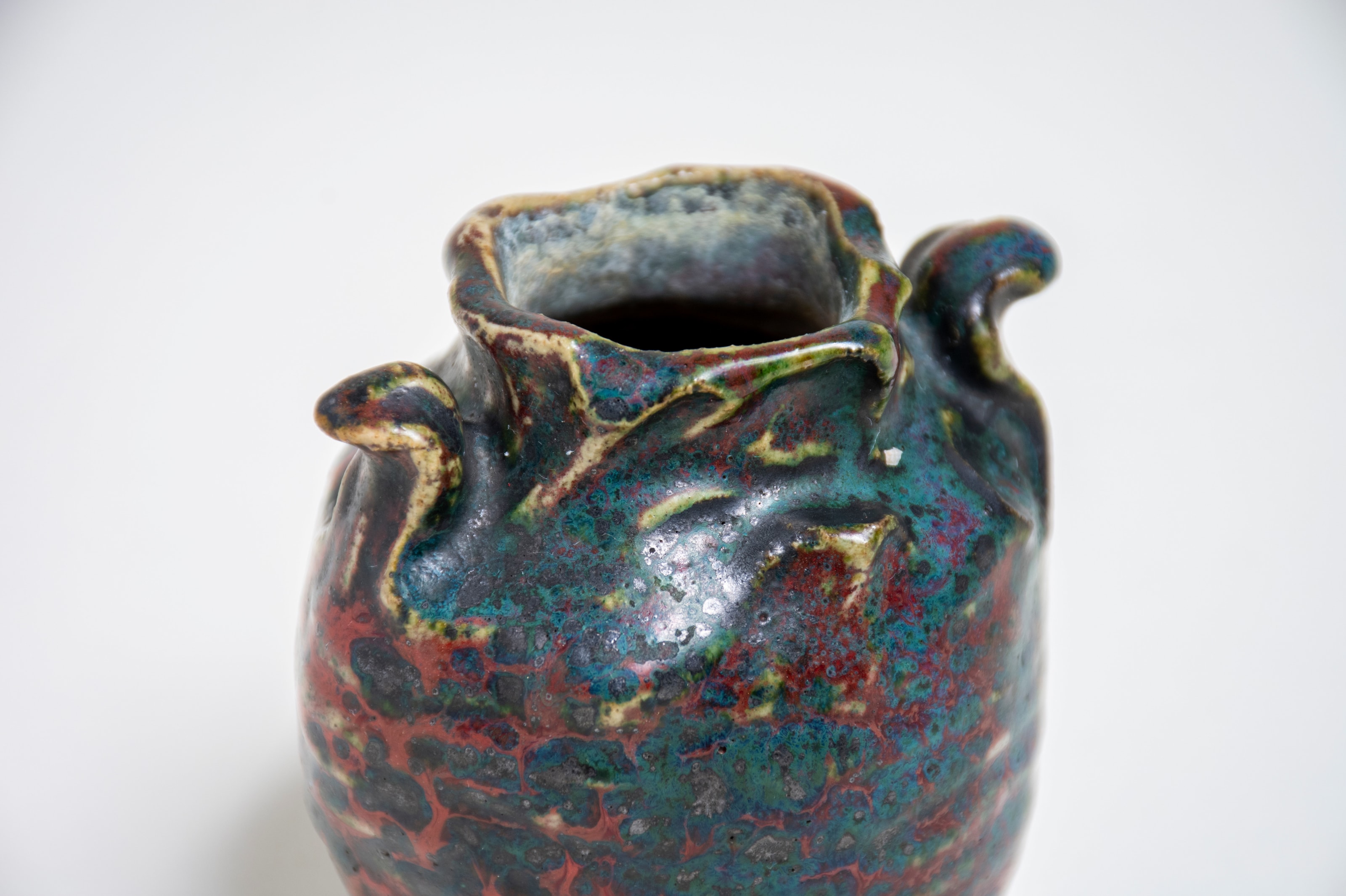 showcasing the vibrant colors and irregular texture of the glaze rouge dalpayrat, oxblood or sang de boeuf glaze that Pierre adrien dalpayrat was famous for,