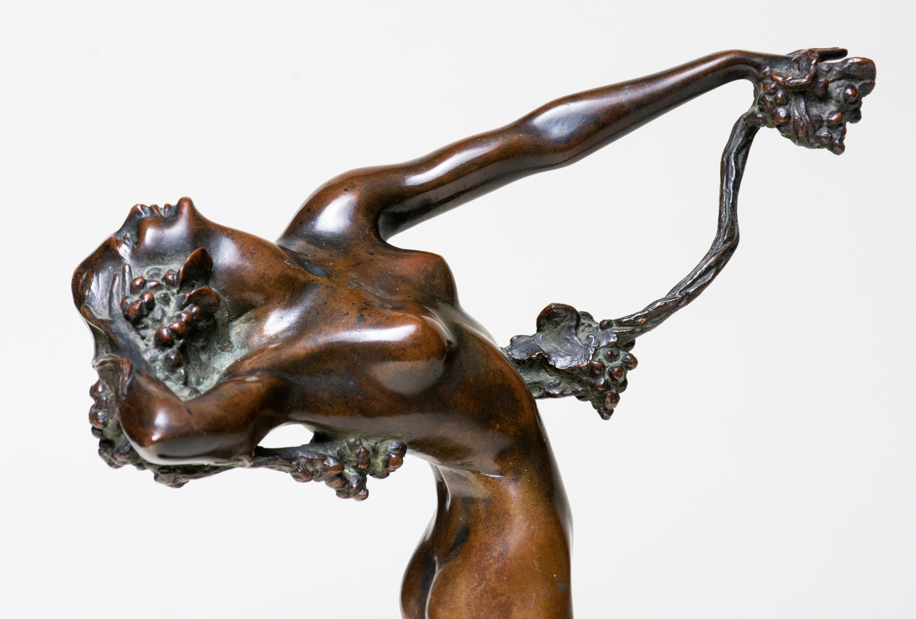 a sculpture of a young woman holding a grape vine by american artist harriet frishmuth