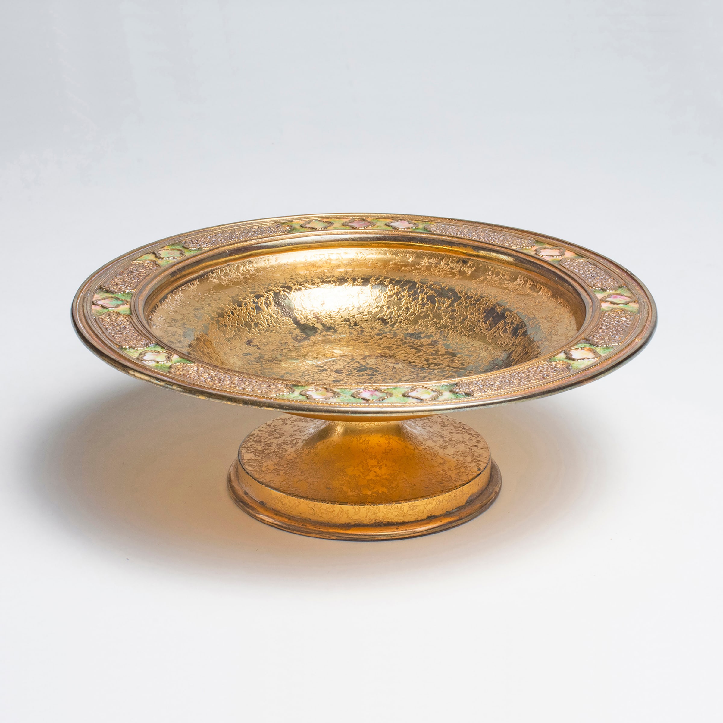 an acid etched bronze footed bowl by louis comfort tiffany with inset green enamel