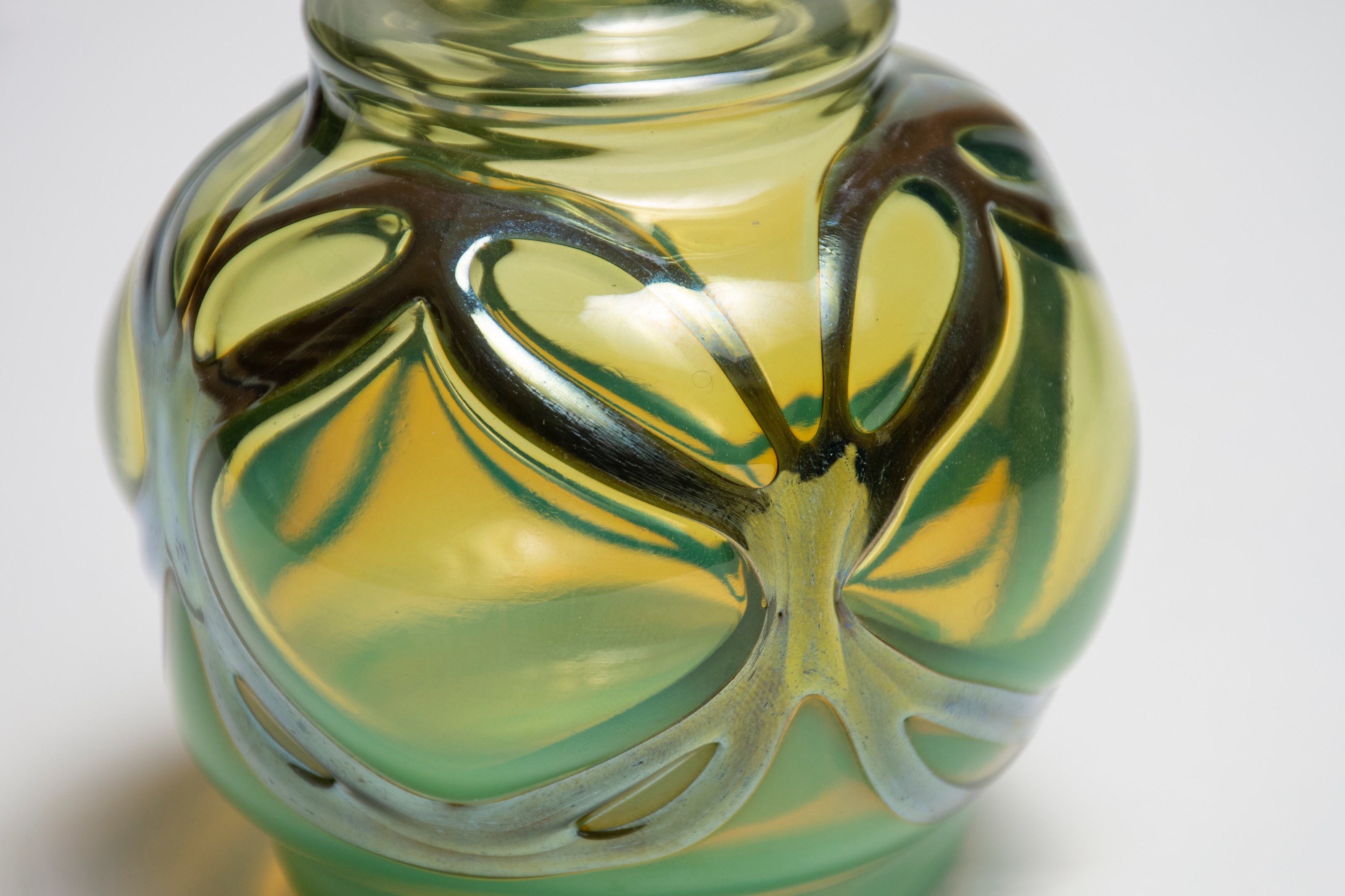 a close up showing the silvery favrile glass which has been applied to this early tiffany cabinet vase to mimic a &quot;blown through&quot; technique used in louis comfort tiffany's metalwork