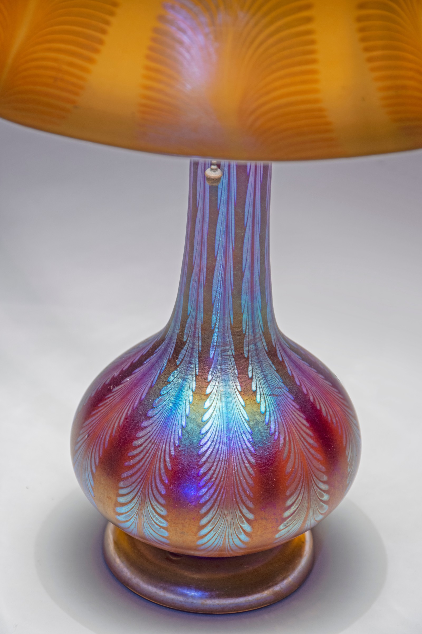 a rare tiffany lamp formed entirely by blown favrile glass, both shade and base in a rainbow iridescent glass with silvery stripes