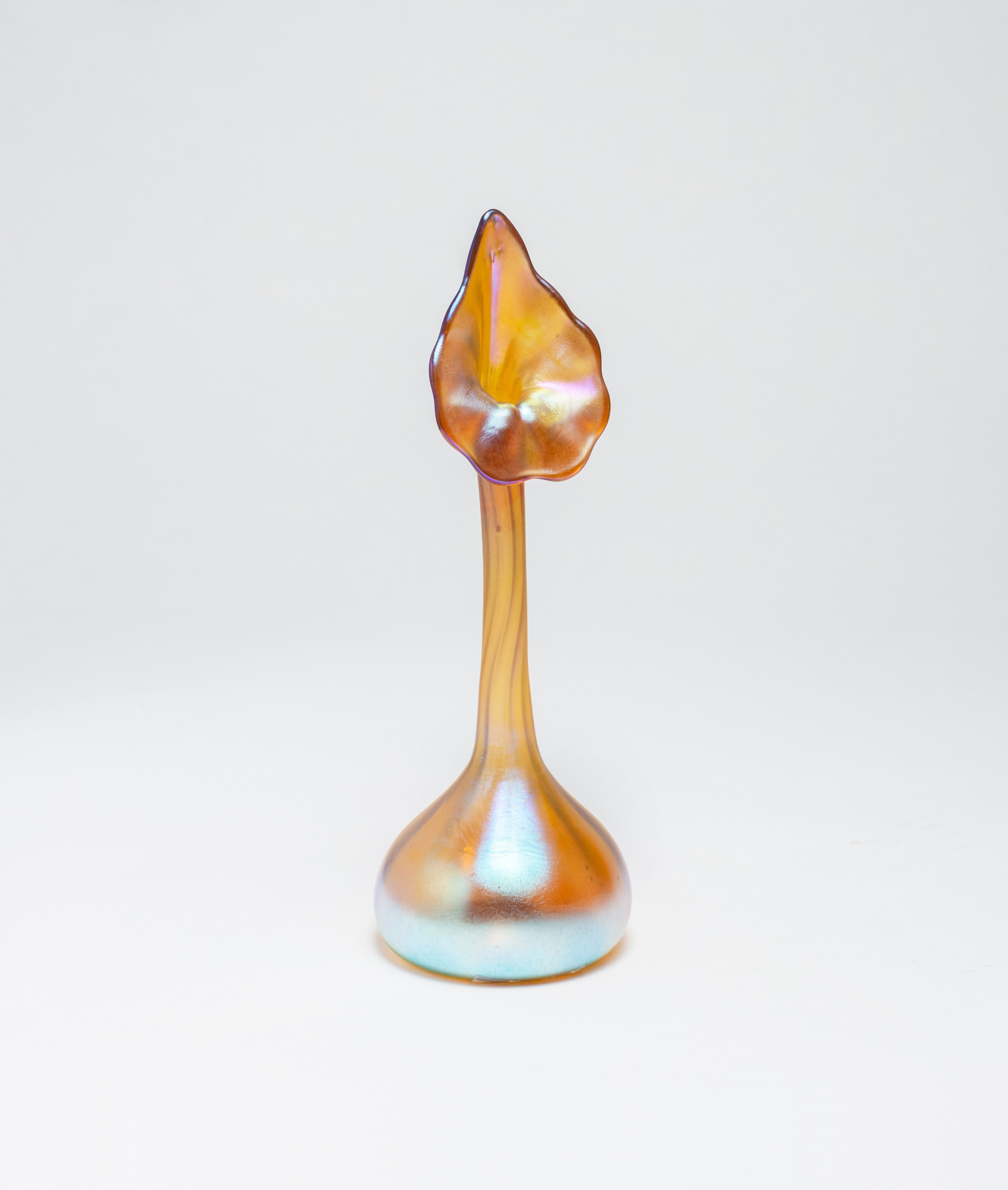 a tiffany favrile glass miniature flower form vase known as the jack in the pulpit, rounded pillow like base rising to a thin stem which terminates in an open flower-like face