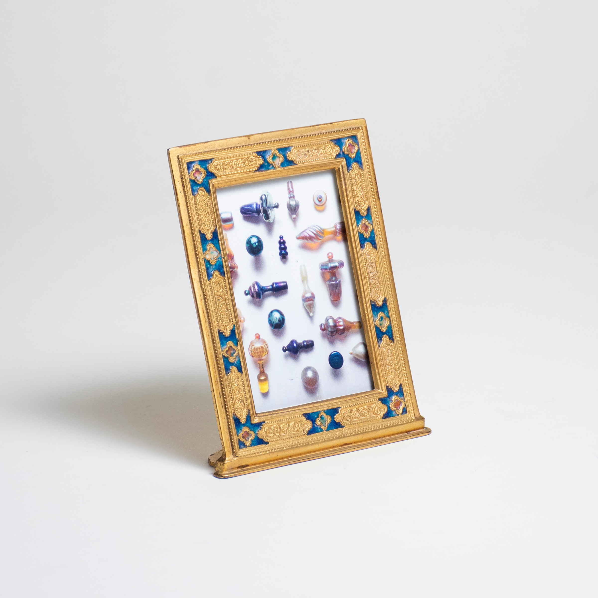 rare vertical calendar frame from the louis c tiffany furances desk set, gilded bronze with twisted wirework decoration and inset sapphire blue enamel