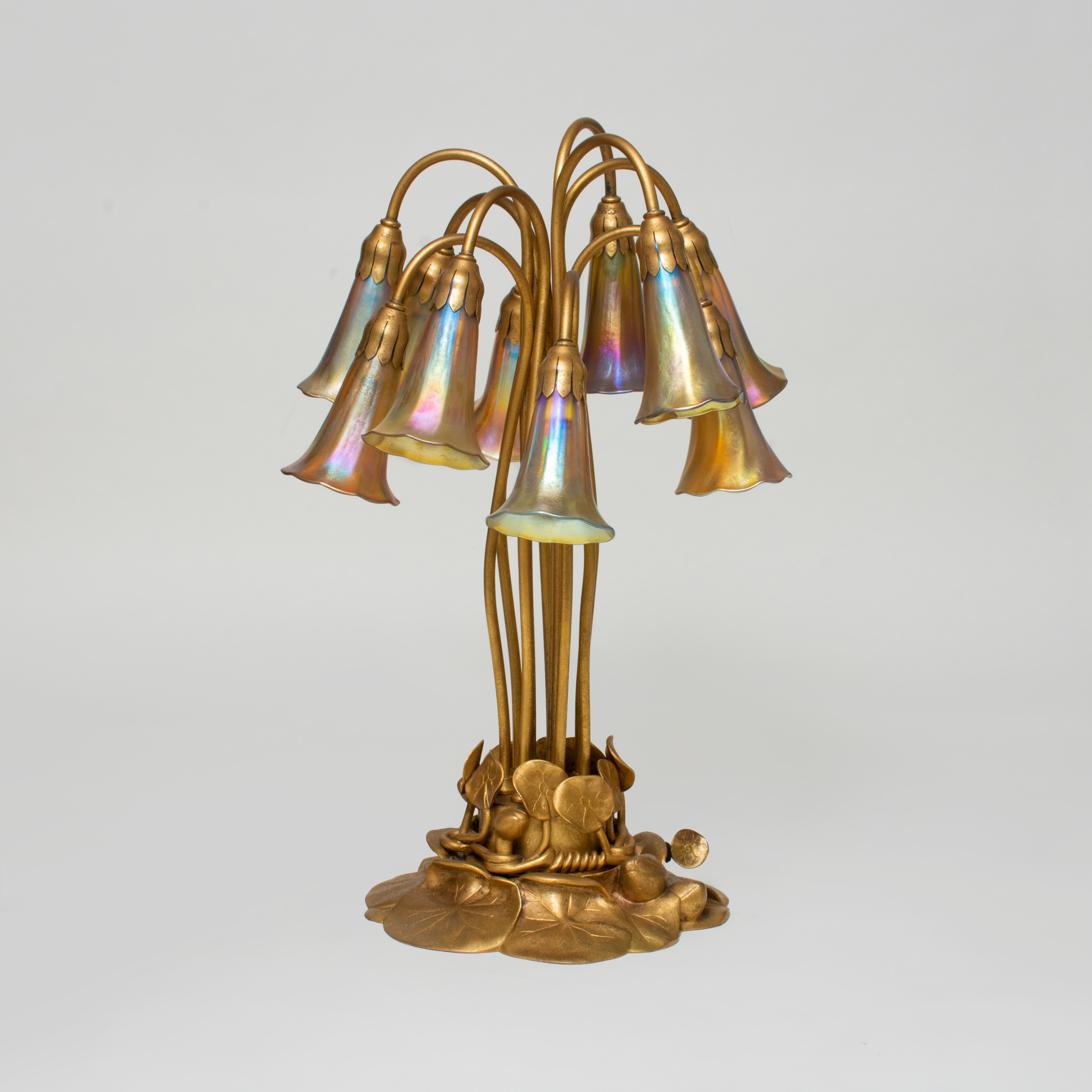 tiffany studios 10 light lily lamp unlit, the bright gold of the base and the gold iridescent tiffany glass shades is showing clearly.