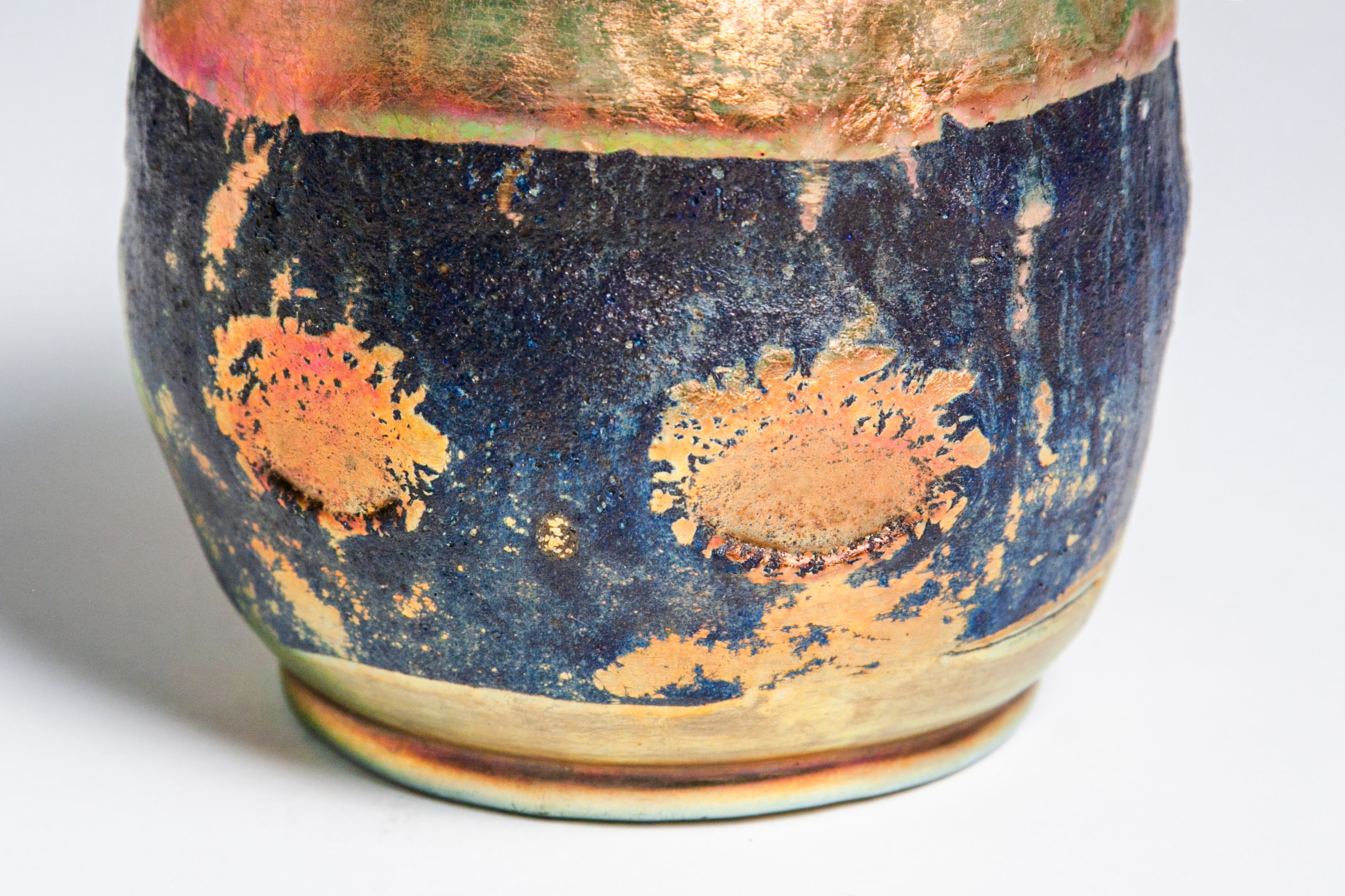 A detail shot showing the droplets of gold iridescent tiffany glass that form a row of polka dots on the rare tiffany lava vase.
