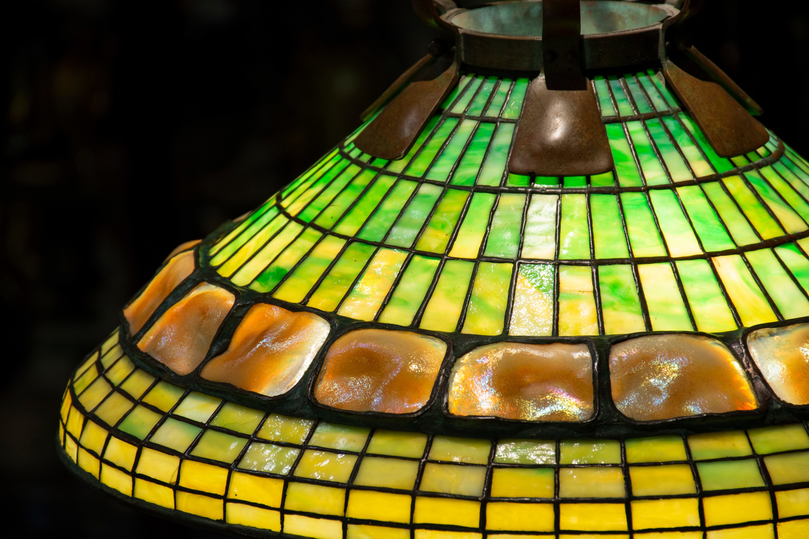 A detail shot showing the Tiffany Studios hanging turtle back shade, showcasing the leaded glass and irregular texture and iridescence of the favrile glass turtle back tiles