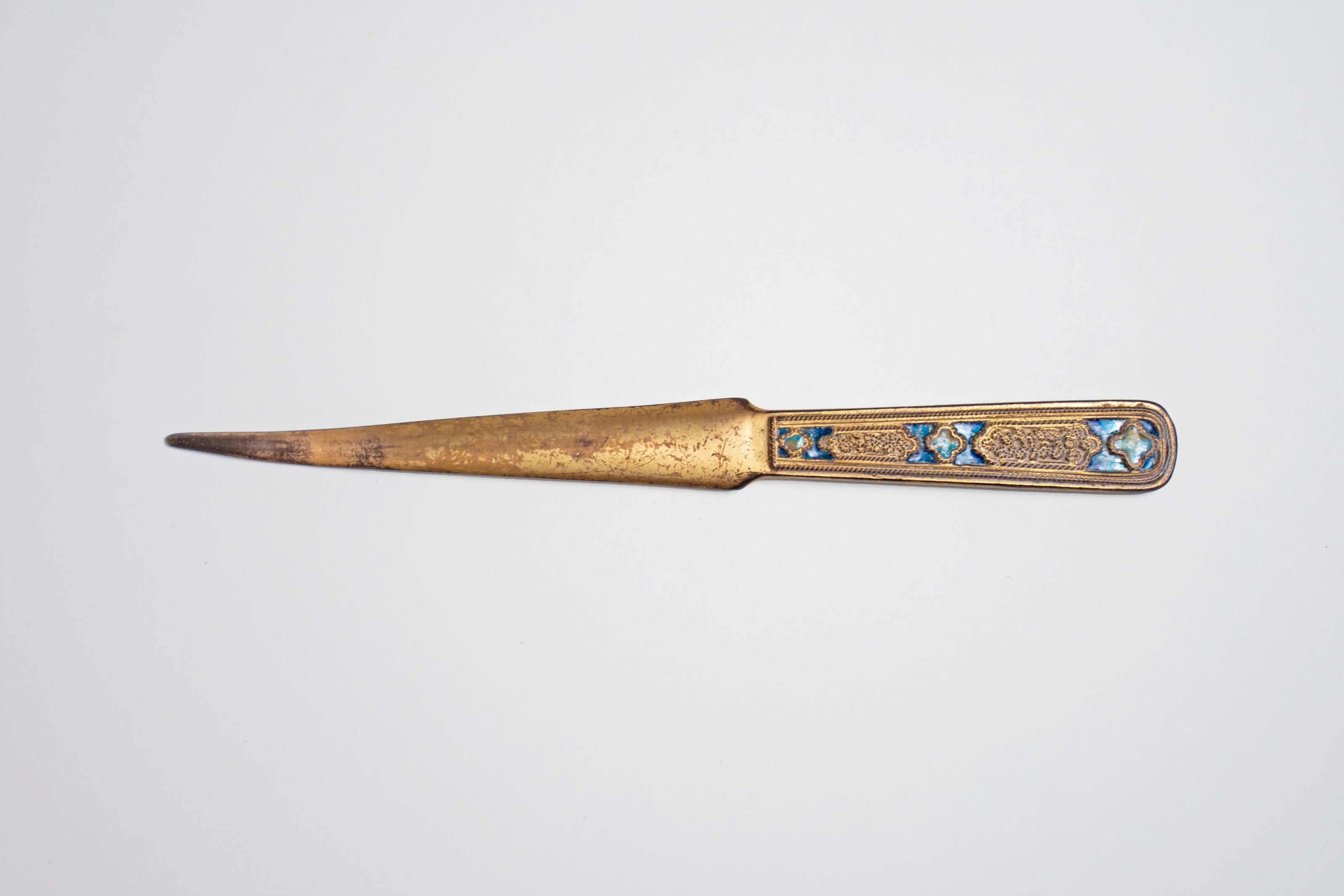 a blue enameled letter opener in gilt bronze by louis c tiffany furnaces with rich jewel toned enamel