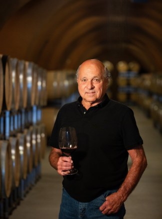 David Abreu Kenzo Estate viticulturist holding a glass of wine