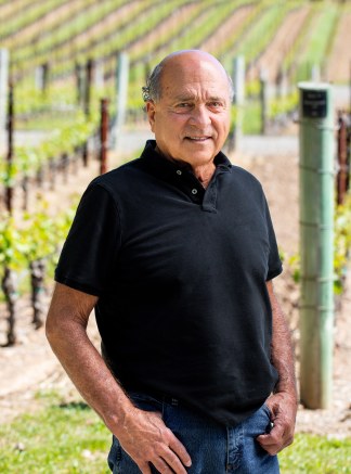 David Abreu Kenzo Estate viticulturist holding a glass of wine
