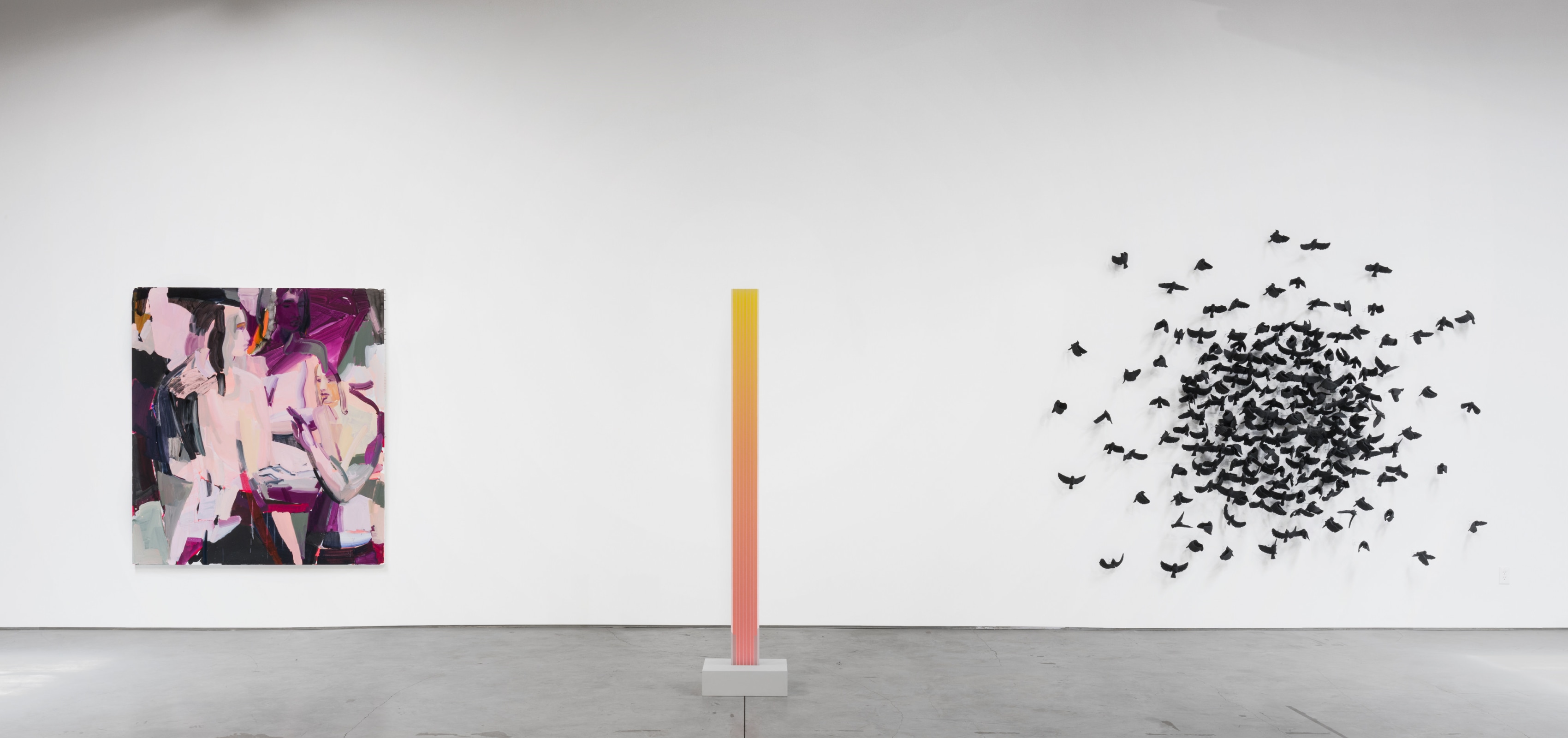 An installation by Camilla Taylor of ceramic black sparrows mounted to the wall.