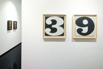 Installation image of the exhibition Robert Indiana at the Pinacoteca Comunale Casa Rusca in Locarno, Switzerland. Shown are the black and white paintings Three and Nine