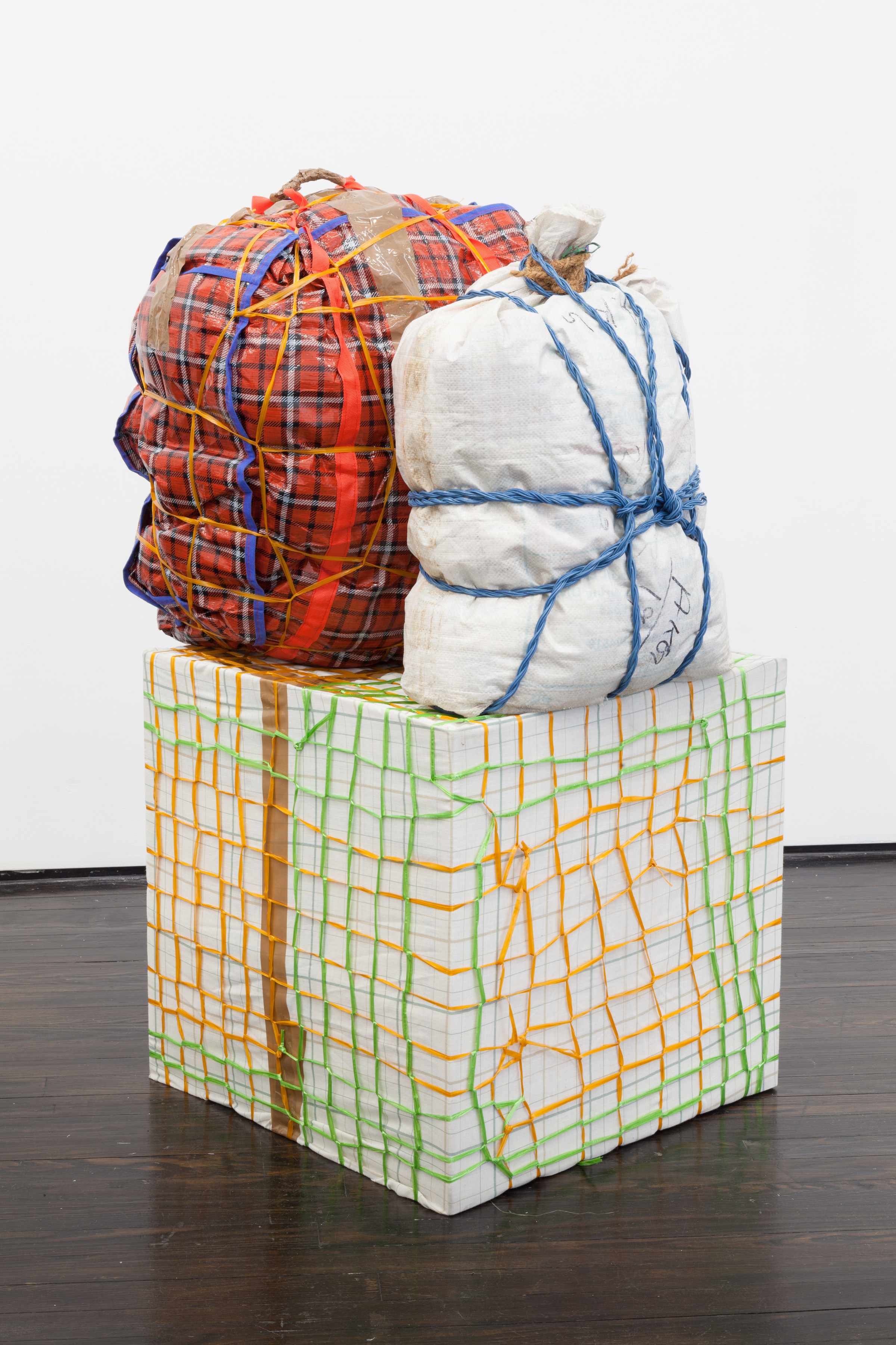 Sculptural piece shaped like baggage bound together