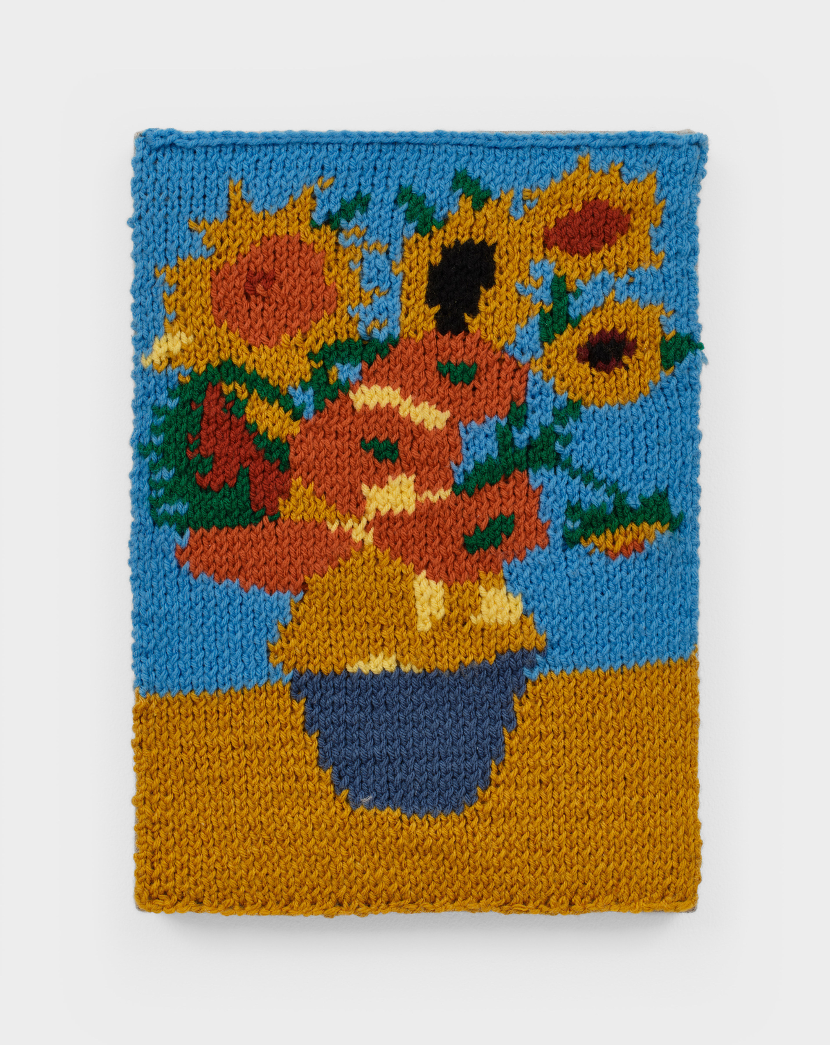 A knit artwork depicting a vase full of sunflowers, sewn into linen and stretched.