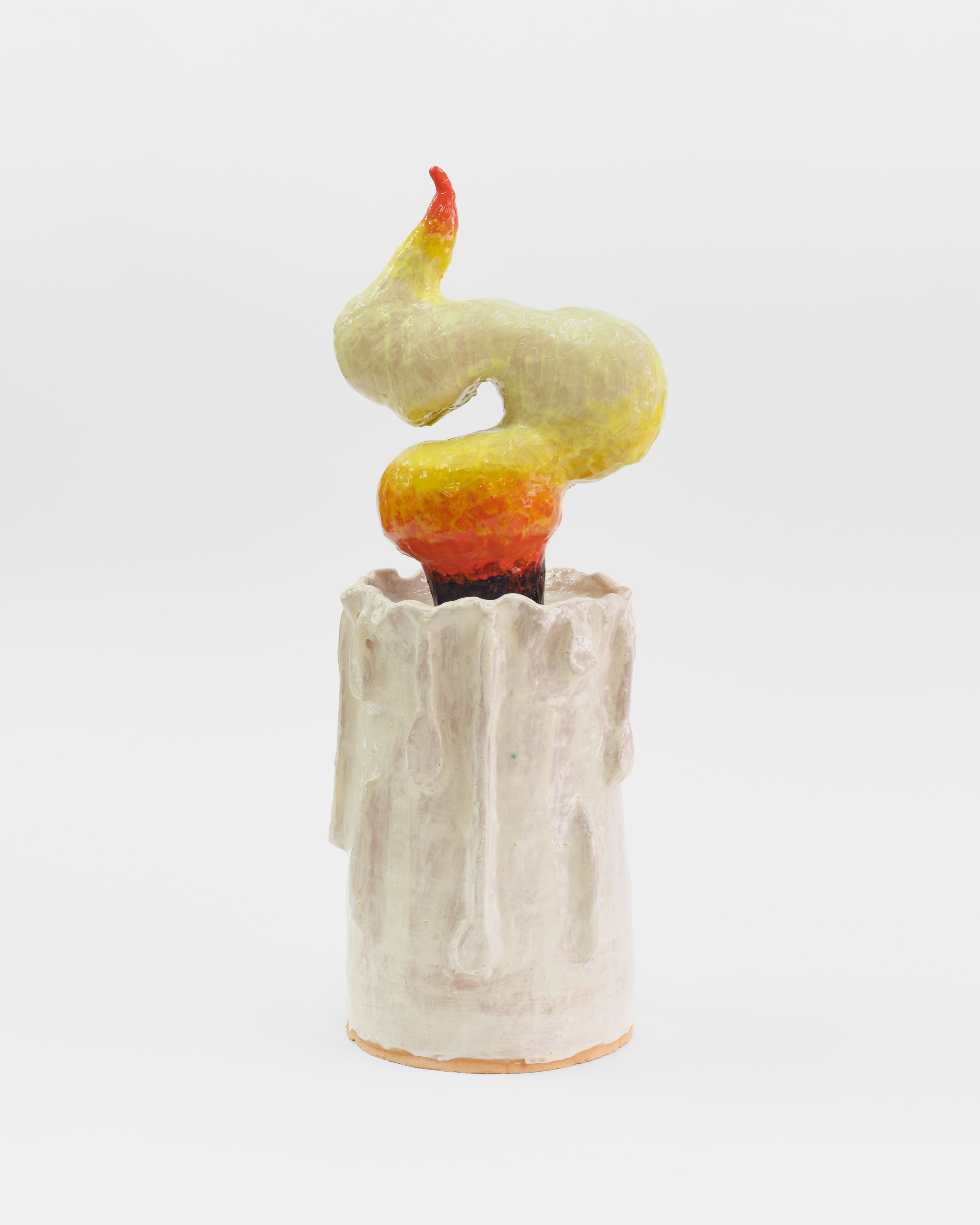 A ceramic sculpture of a large white burning candle.