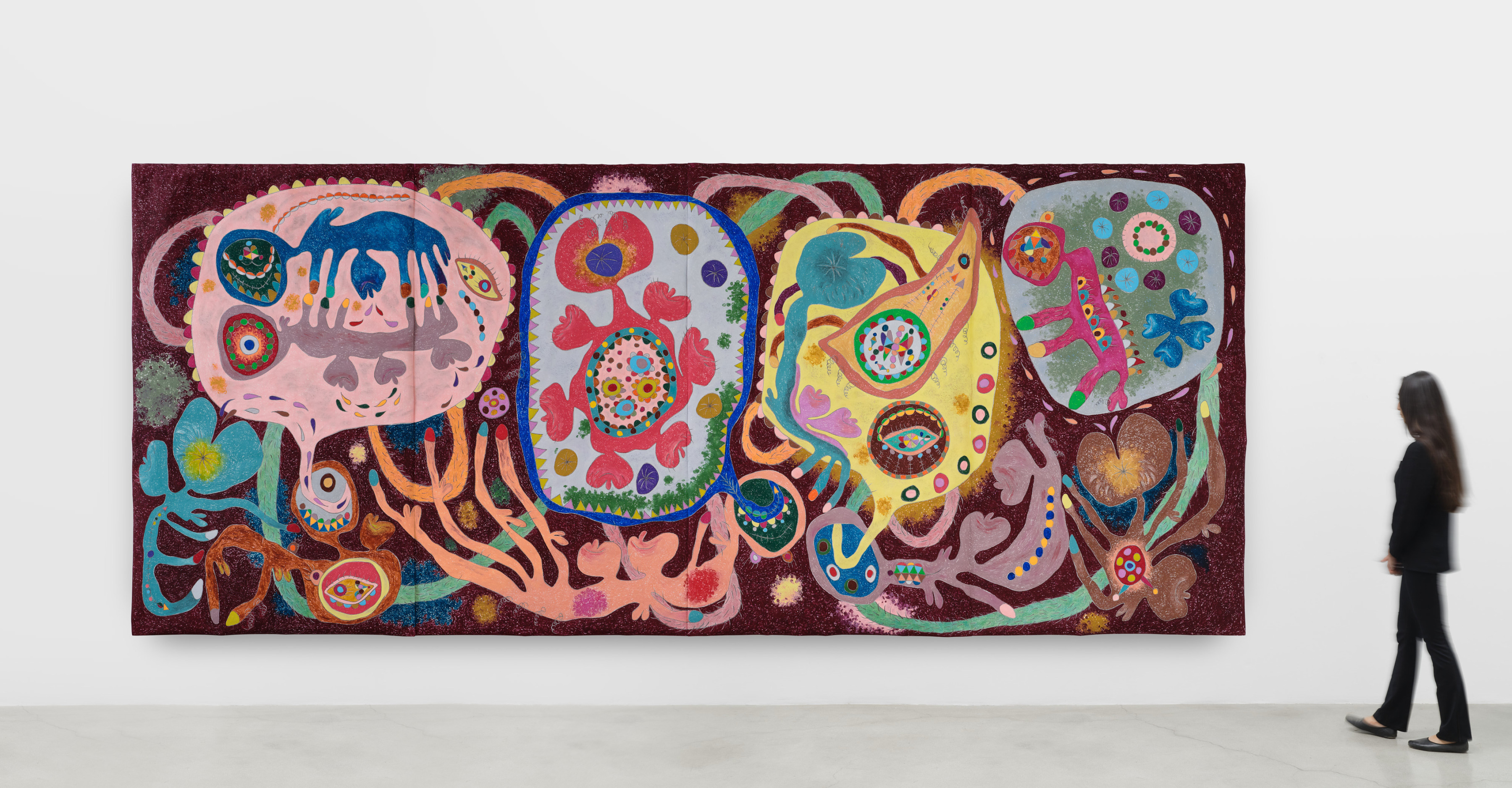 A large four panel work in vibrant purple, pink and blue tones of anthropomorphic interlocking shapes.
