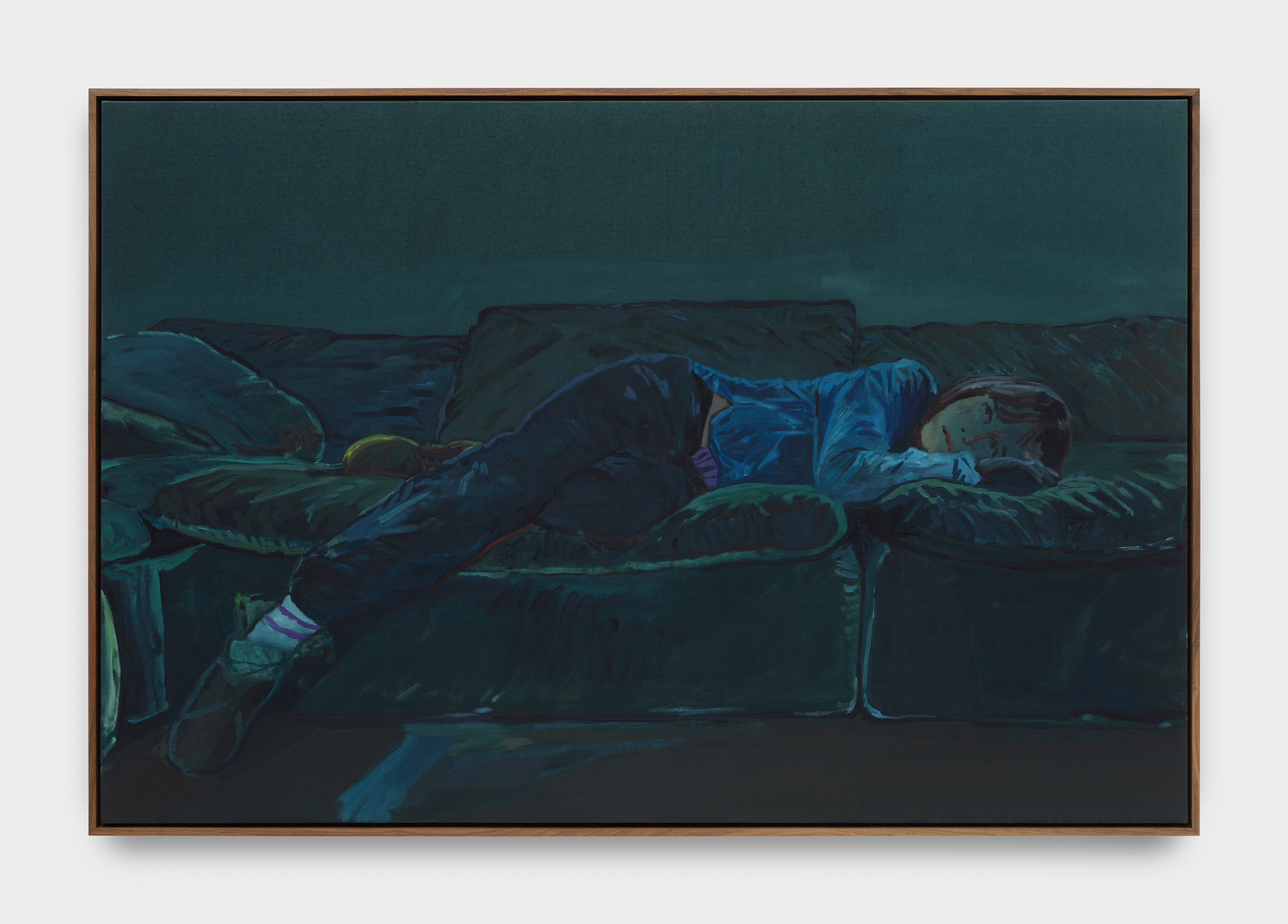 A self portrait of the artist lying on a dark green couch.