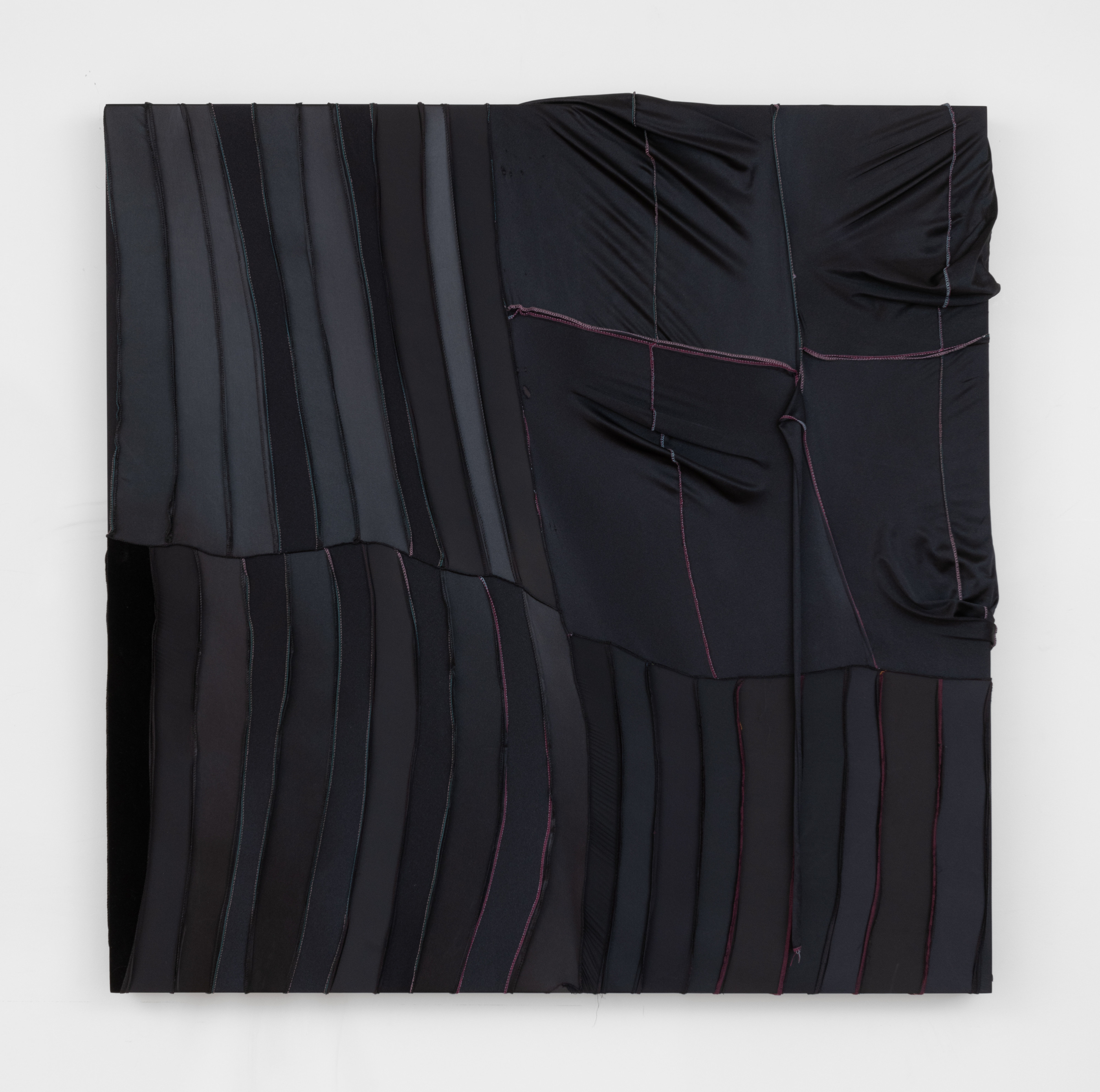 A square painting made from black durags sewn into rectangular panels stretched tightly on the left side and hanging with slack on the right side. 