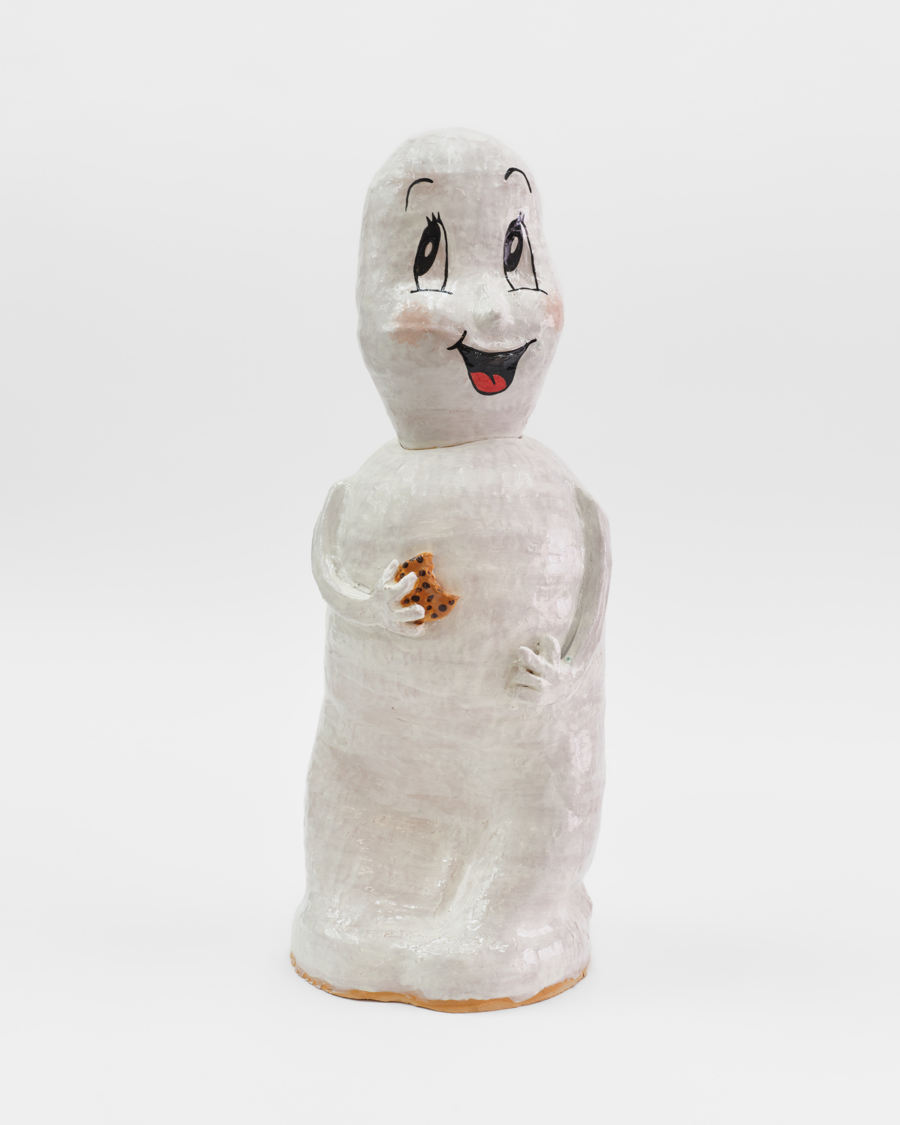 A ceramic sculpture of Casper the friendly ghost holding a chocolate chip cookie. 