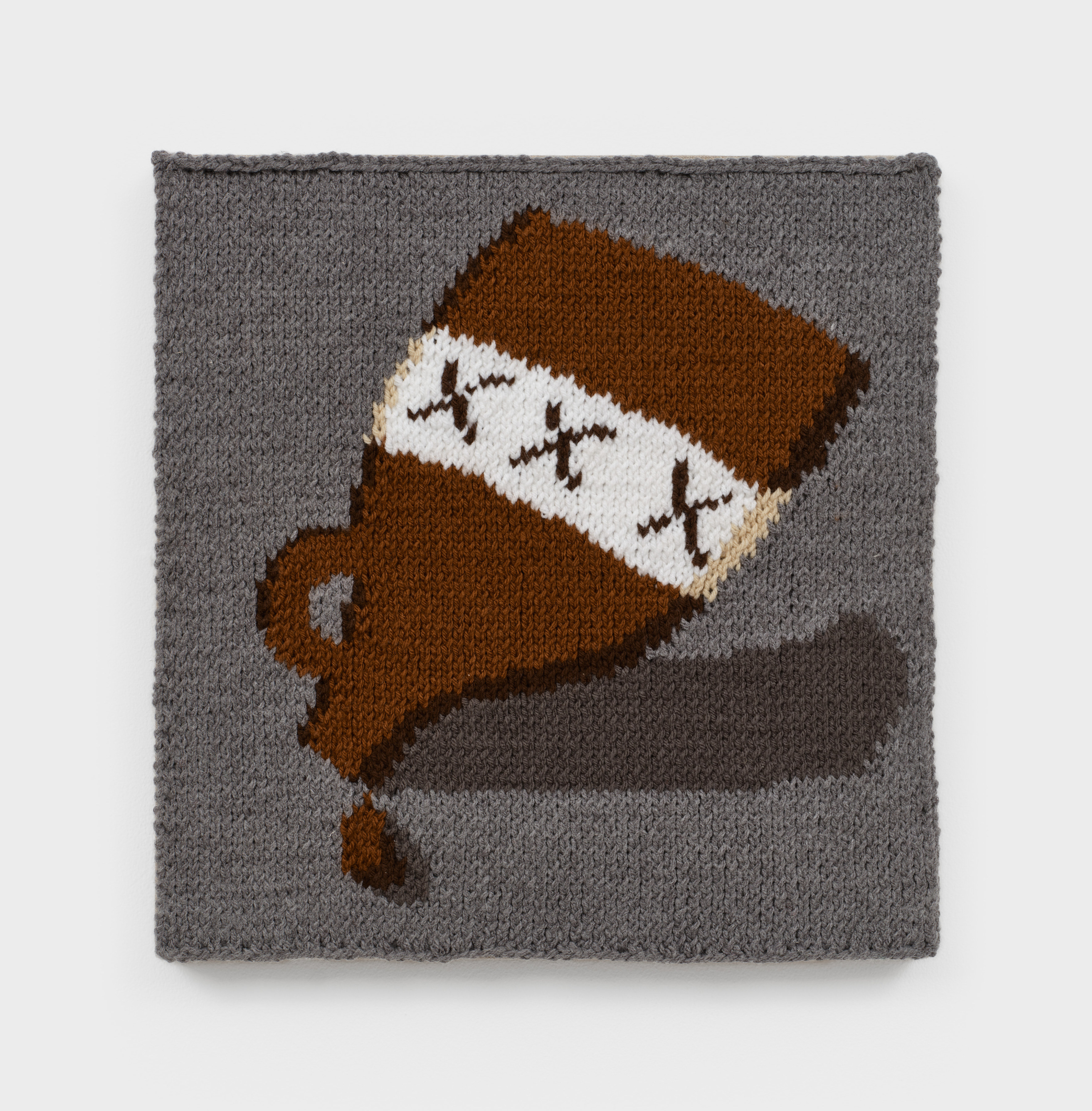A knit artwork depicting an upside down brown liquor bottle spilling onto a grey background, sewn into linen and stretched.