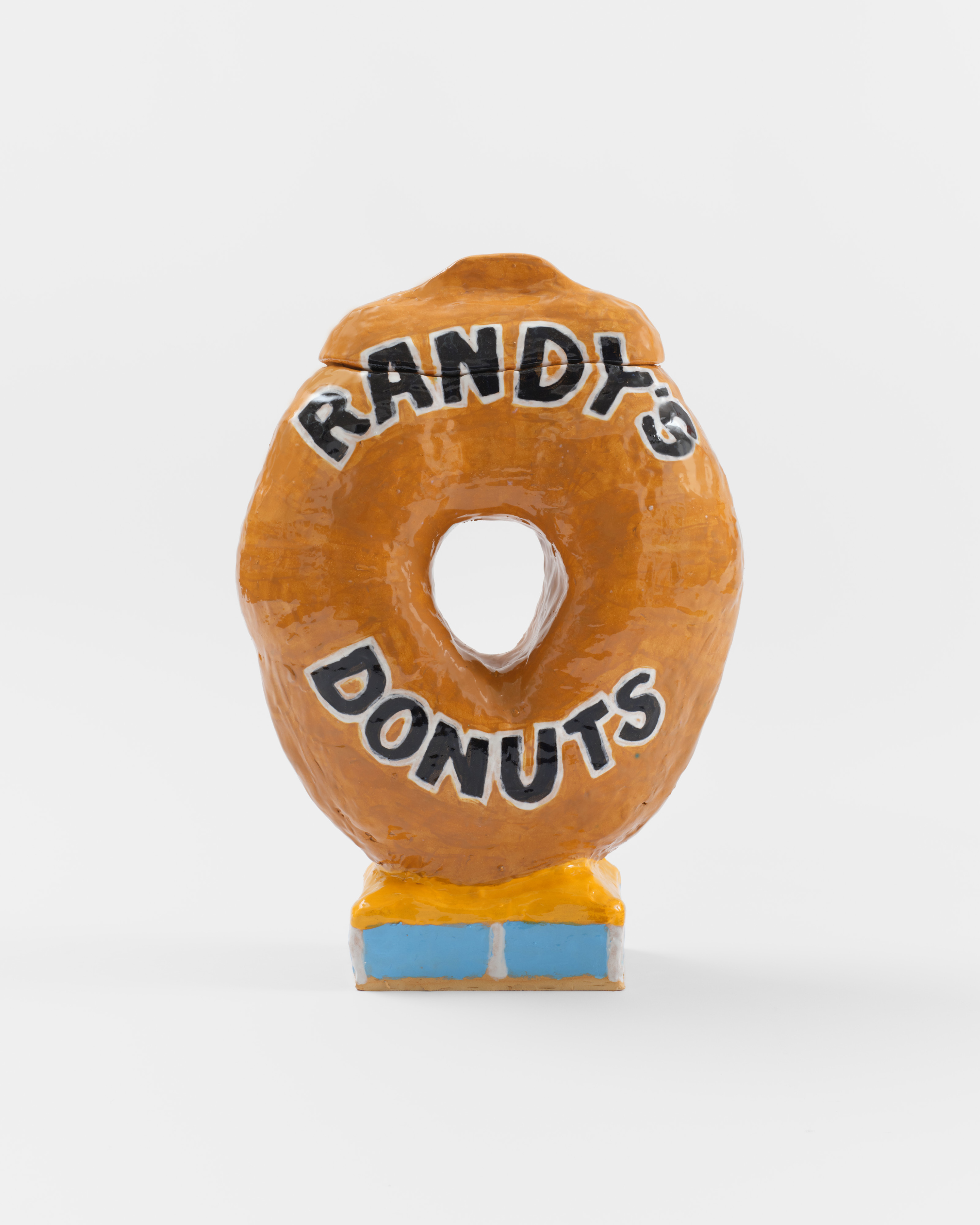 A ceramic sculpture of a donut resembling the Los Angeles landmark "Randy's Donuts" donut sculpture. 