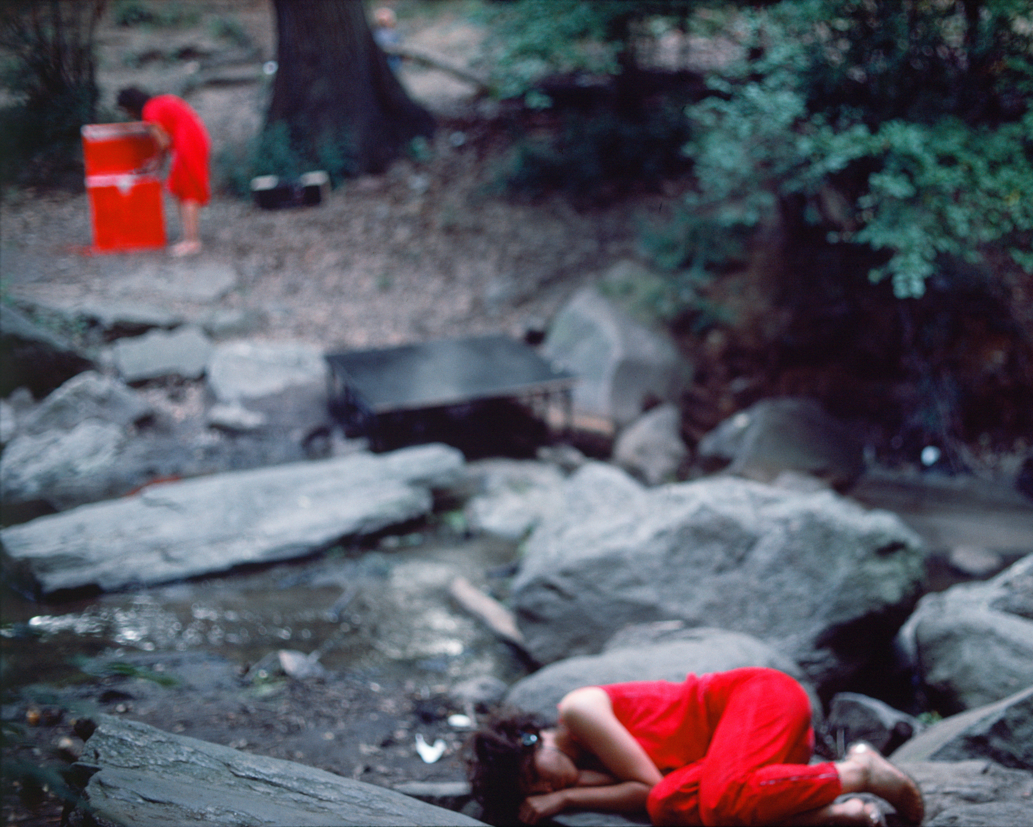 Rivers, First Draft: The Woman in Red cooks, and the Teenager in Magenta lies curled across the stream, 1982/2015, Digital C-print from Kodachrome 35mm slides in 48 parts, 16h x 20w in (40.64h x 50.80w cm)