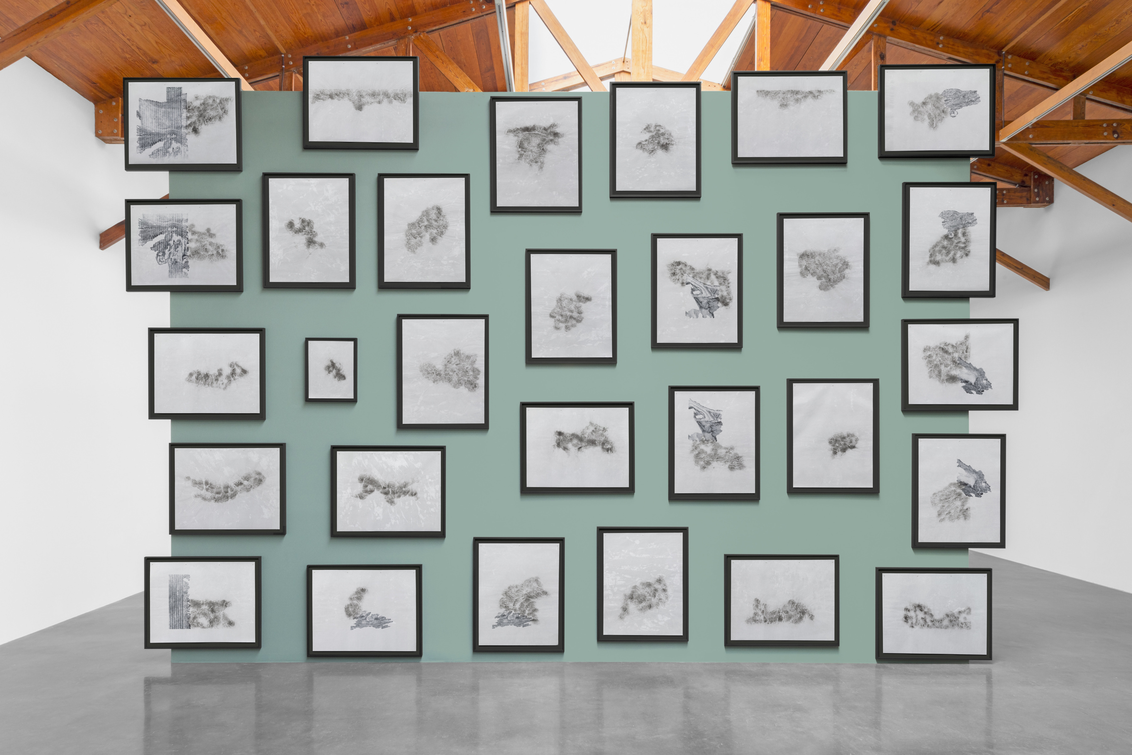 Installation view of&amp;nbsp;Tracing Vista (STA XXIX, Giornate 1-29), 2025, set of 29, ink, graphite powder and intonaco on perforated and printed paper, installed: 500 x 700 cm (196 7/8 x 275 5/8 in)