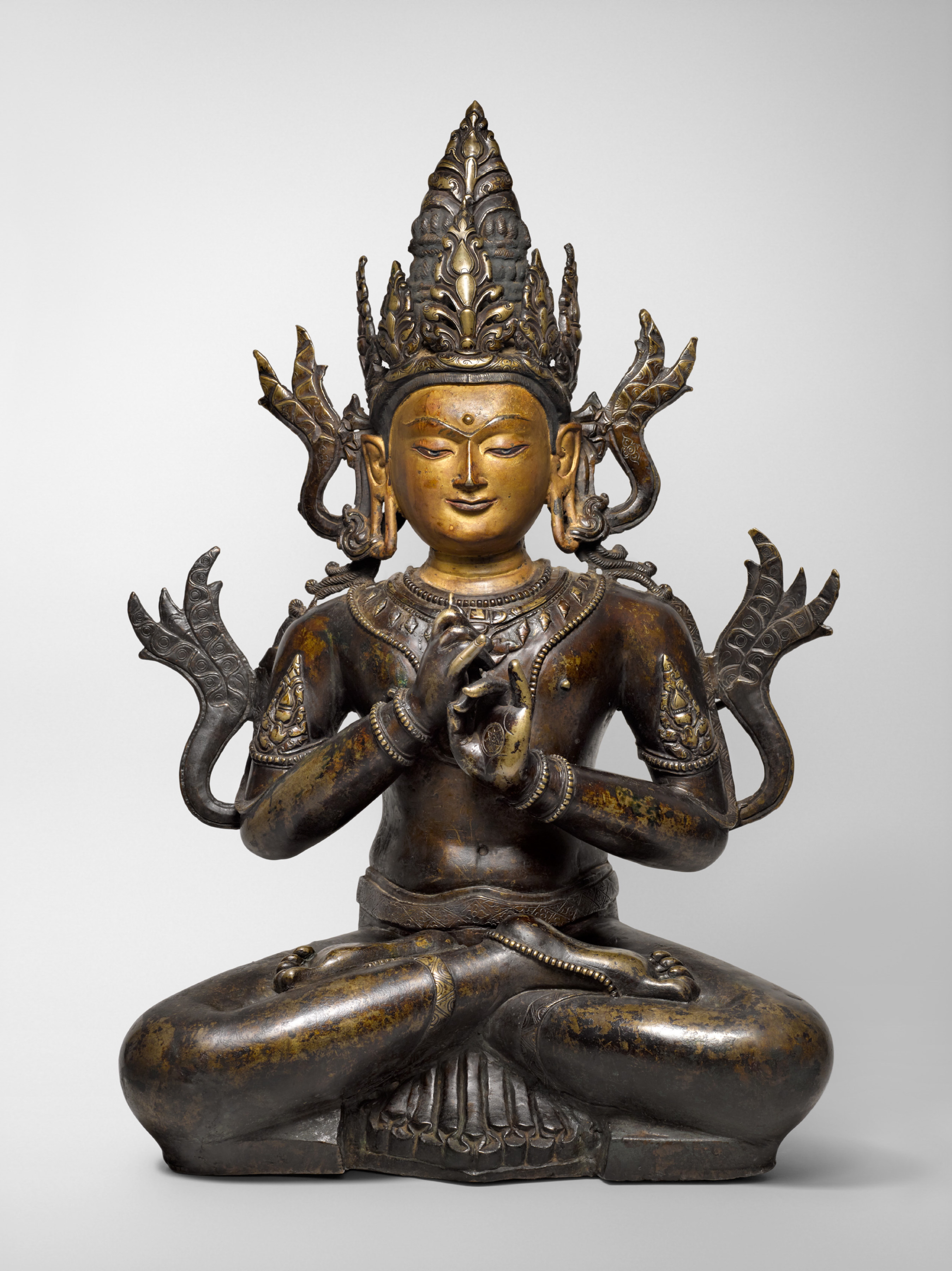 The form of Vairocana depicted here is identifiable by his distinctive teaching gesture, the bodhyangi mudra 