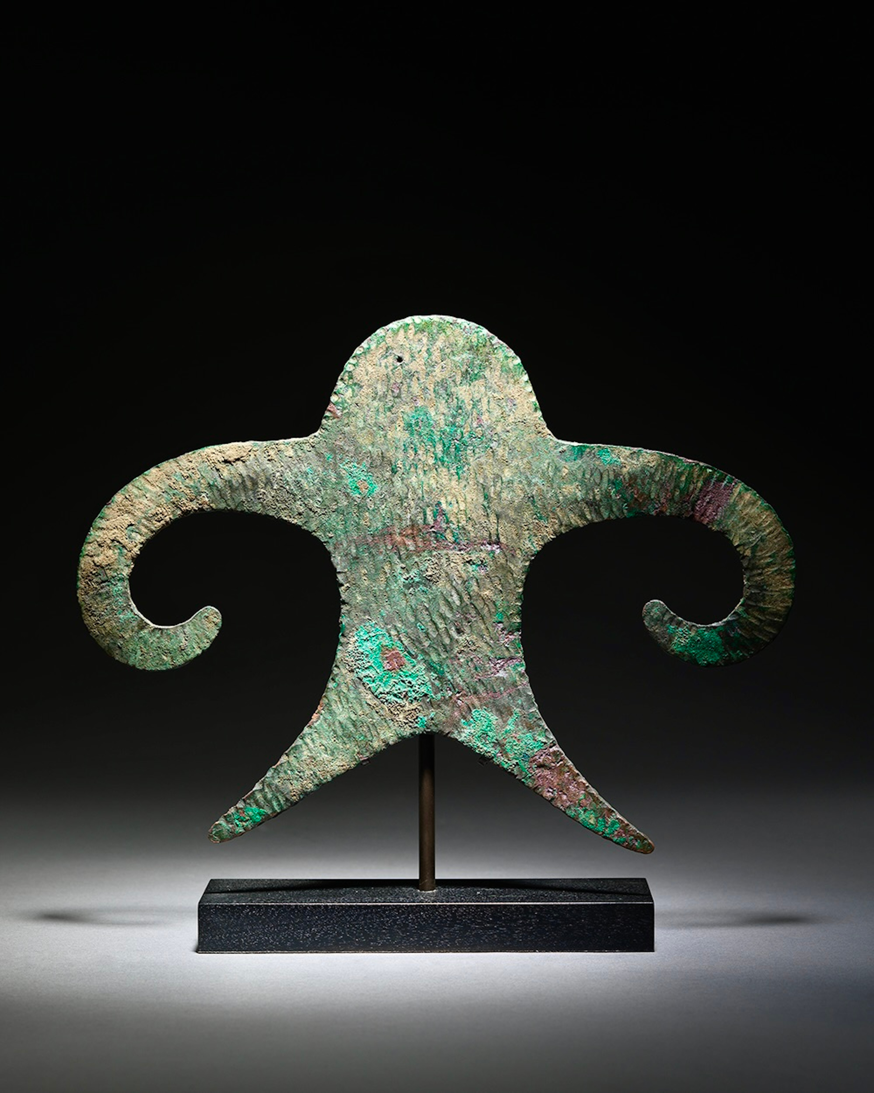 This enigmatic object is cast and hammered from a flat piece of copper into a representation of a male figure.