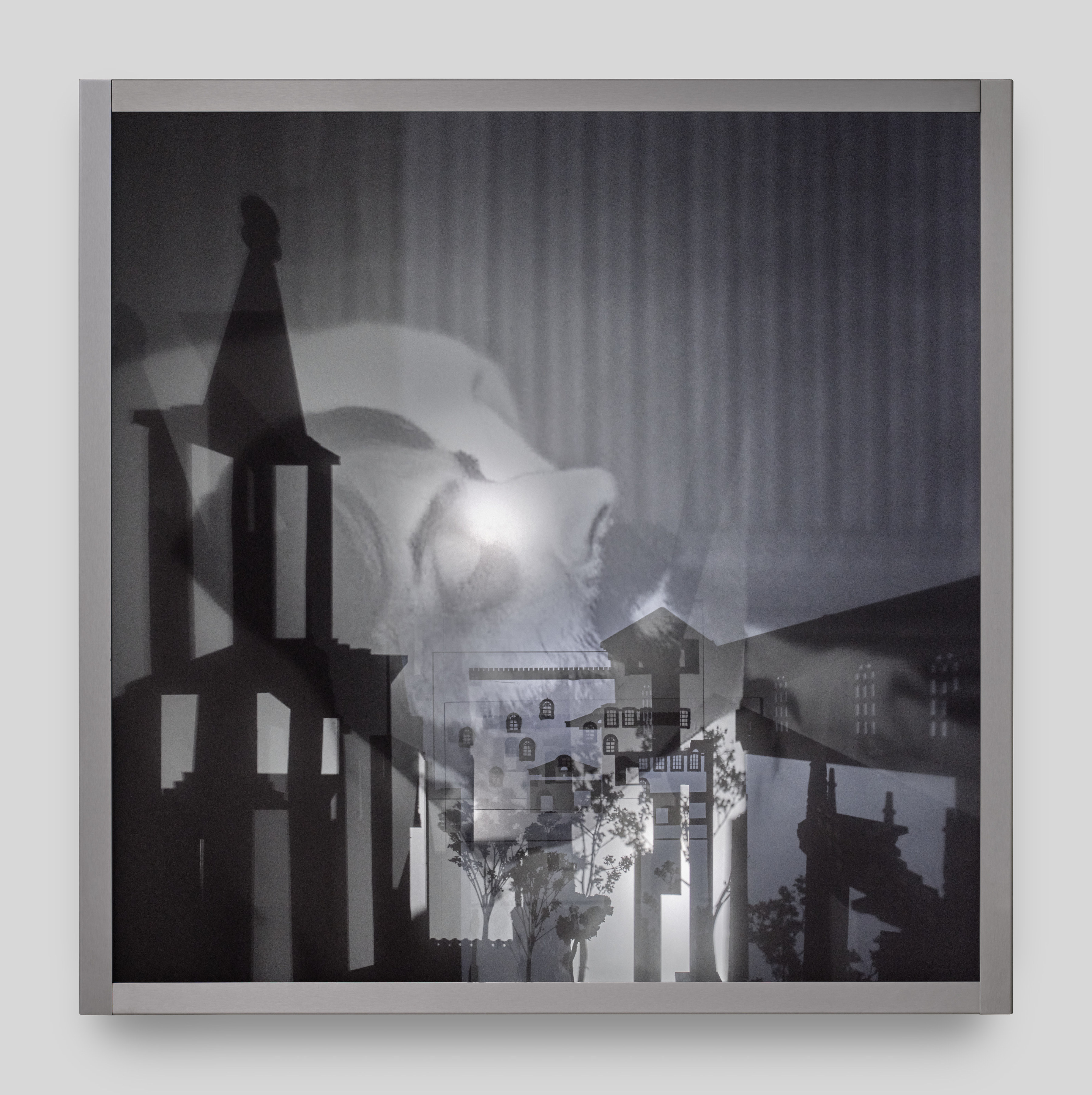 A wall mounted light box sculpture with moving projections of Marcel Proust on his death bed and shadows of steeples and trees. 