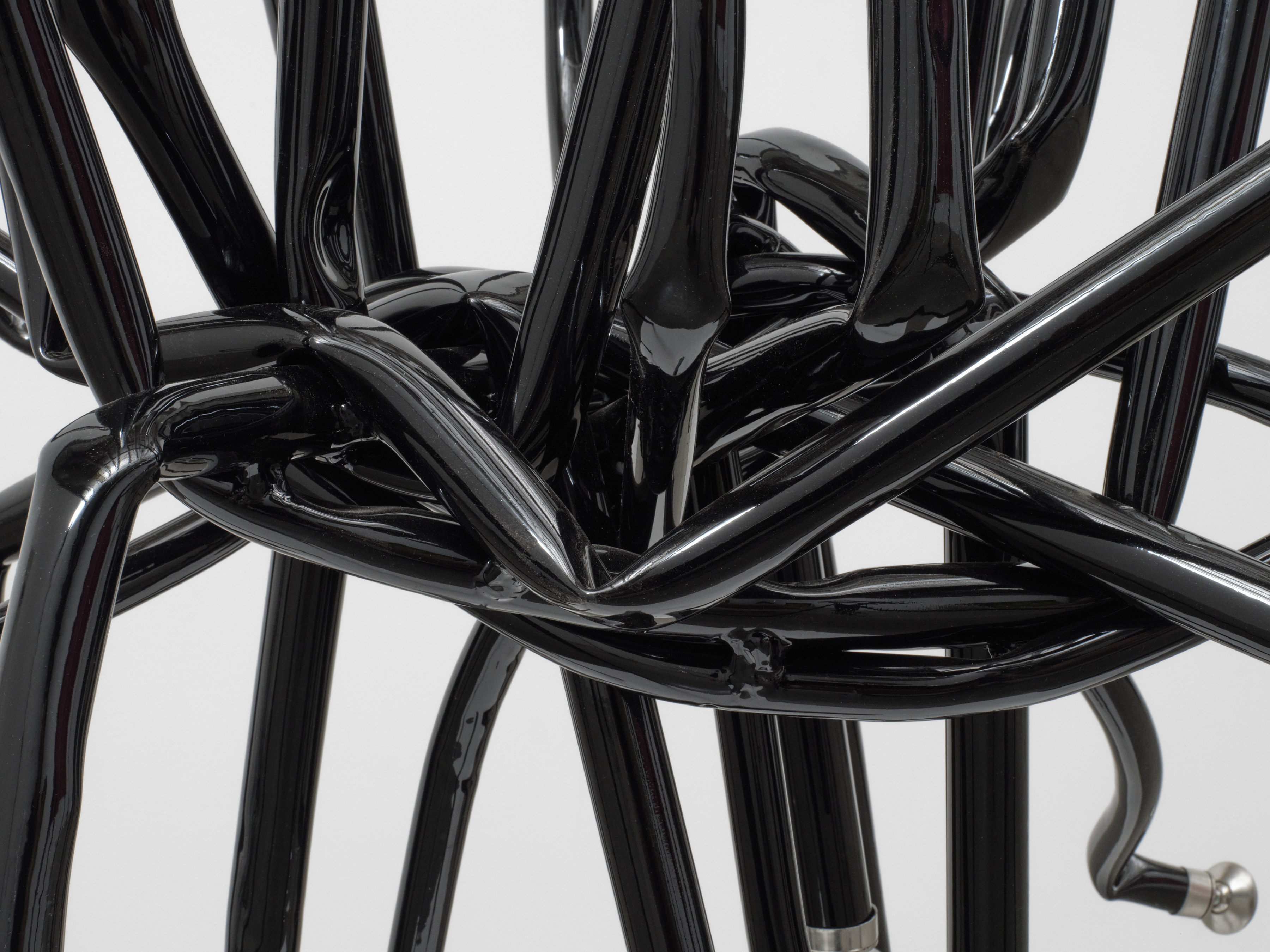 Detail of entangled black steel tubing in Josh Callaghan's "Spider Chair"