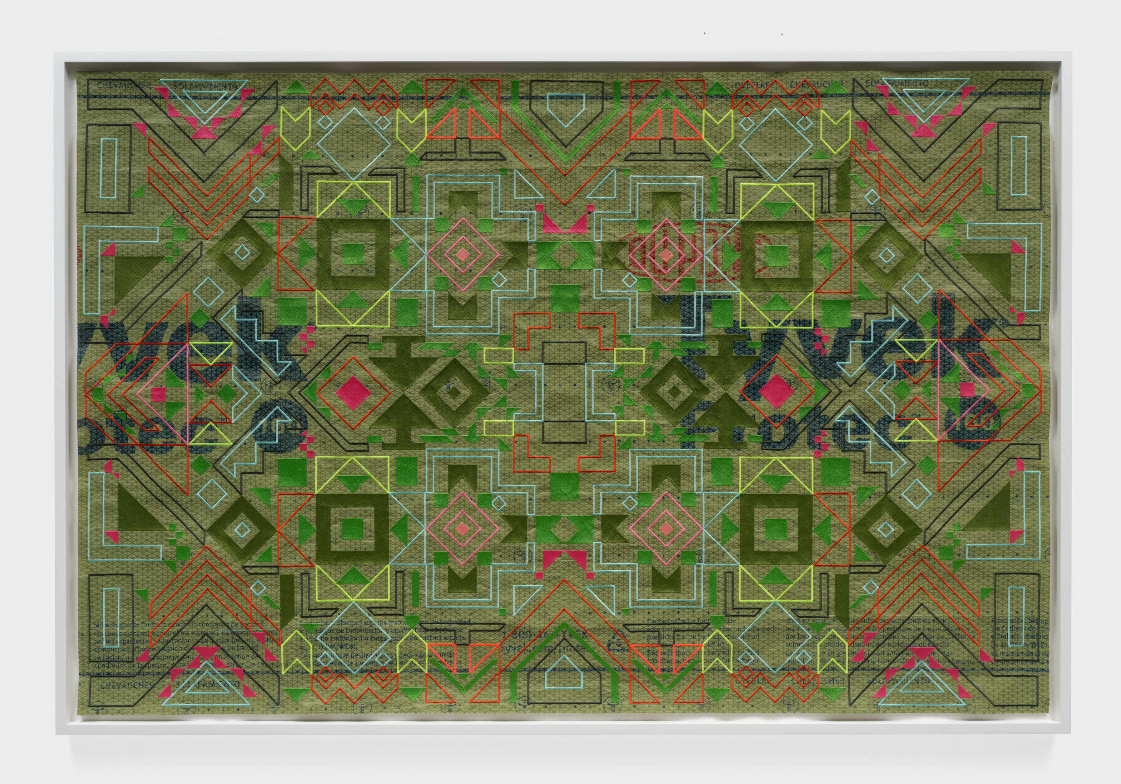 A framed green artwork with orange, red and green patterns sewn into roofing material. 