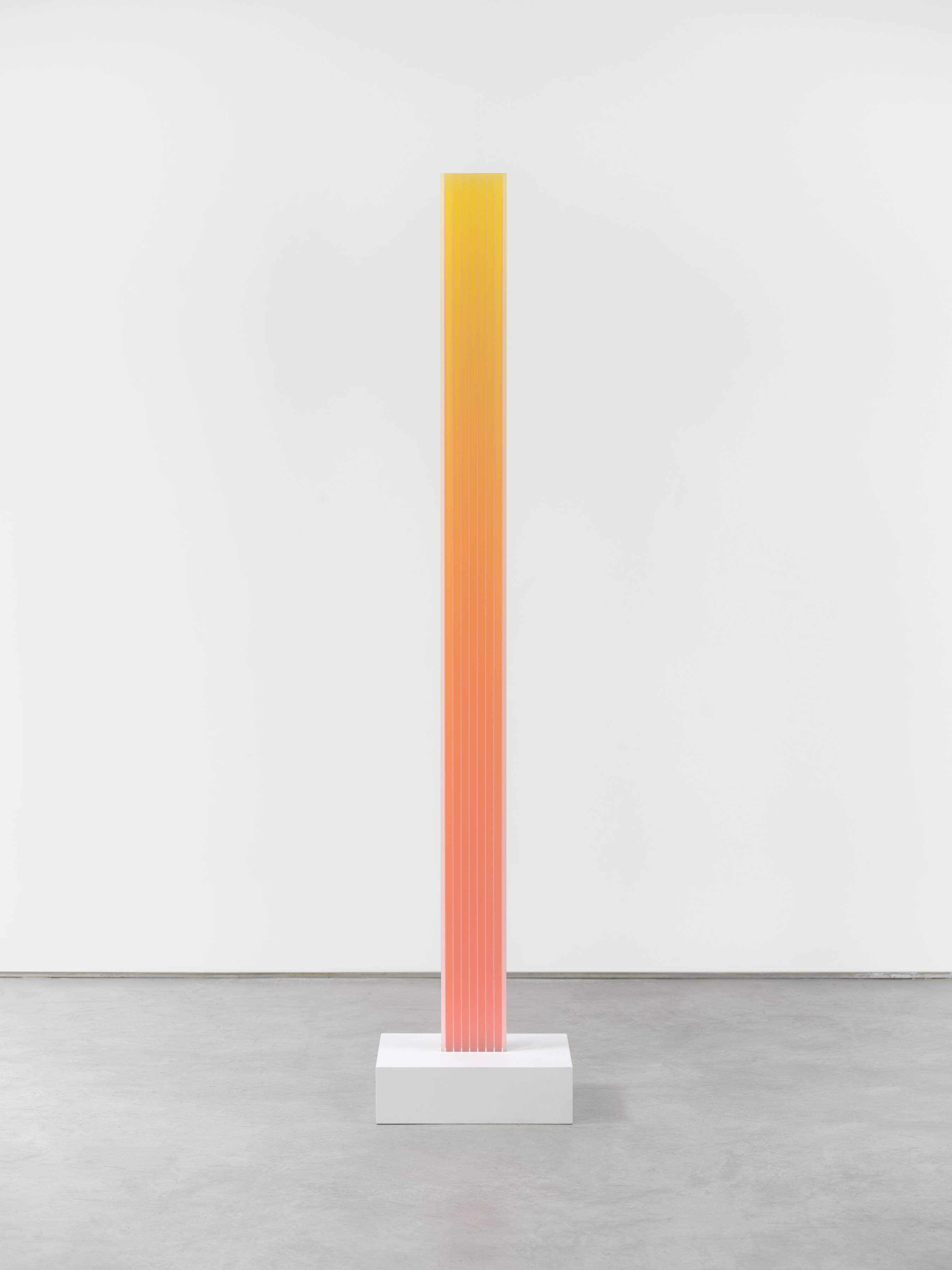 A tall rectangular acrylic sculpture by Eric Zammiitt of a gradient orange with stripes.