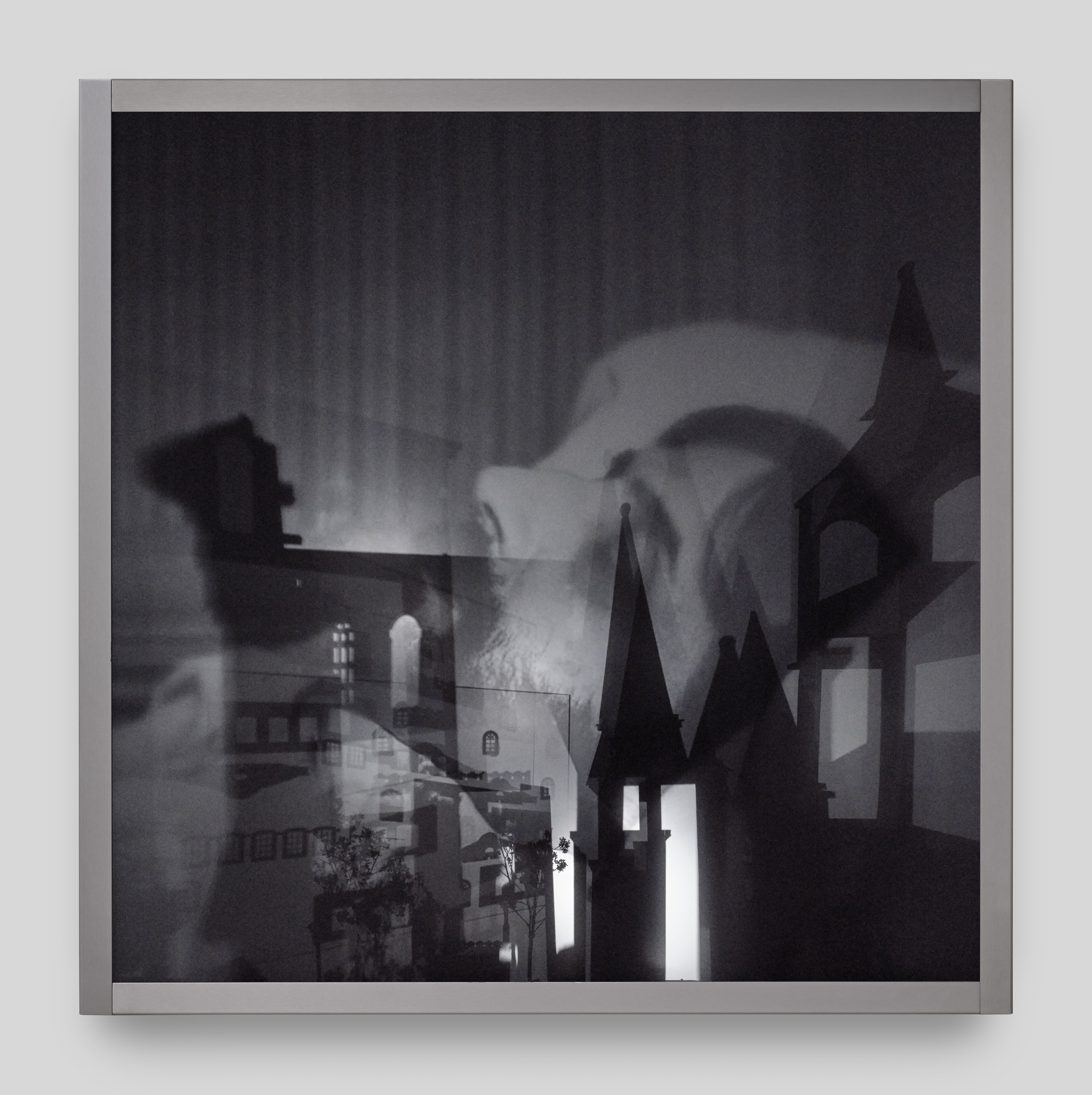 A wall mounted light box sculpture with moving projections of Marcel Proust on his death bed and shadows of steeples and trees. 