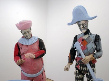 close up of statues around a barrel